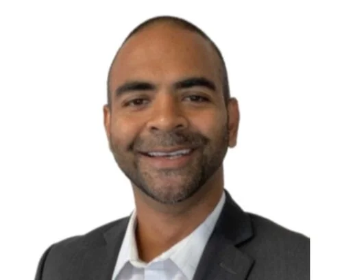 Smiling man in a suit with a white background