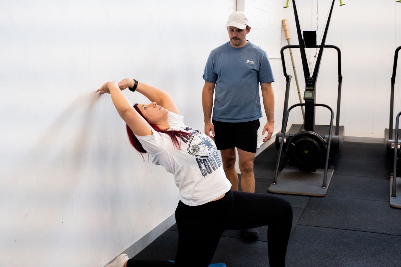 Physiotherapist treating athlete with exercises at Base Movements Physiotherapy Adelaide CBD