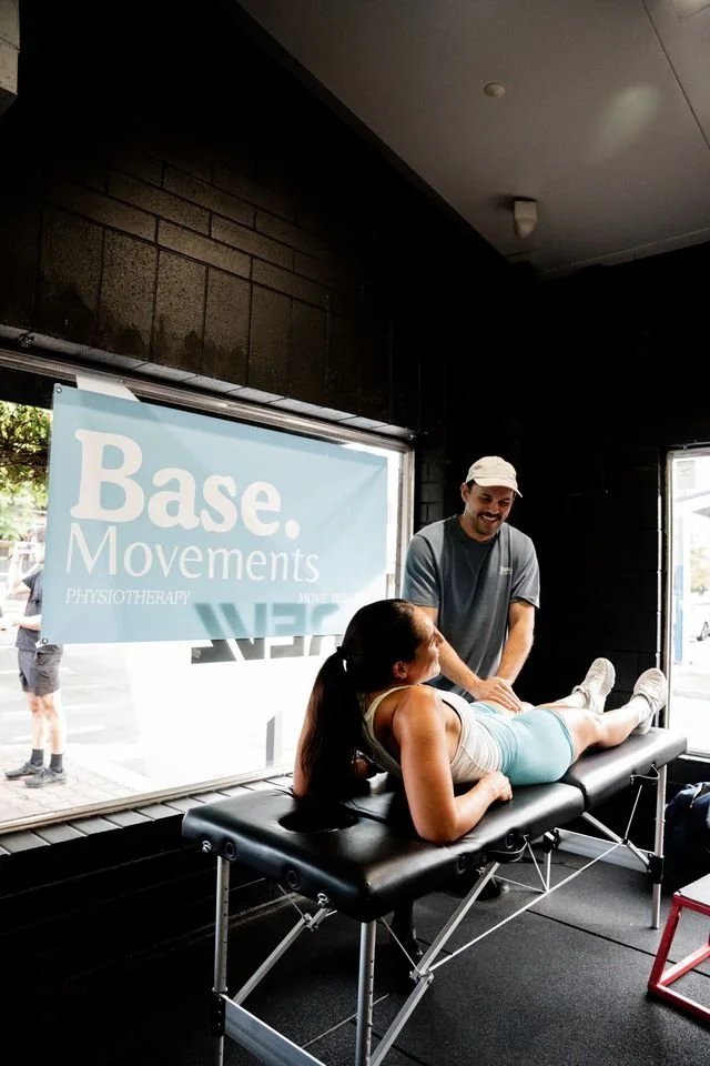 Physiotherapist working at a sports event and treating an athletes knee at Base Movements Physiotherapy Adelaide CBD