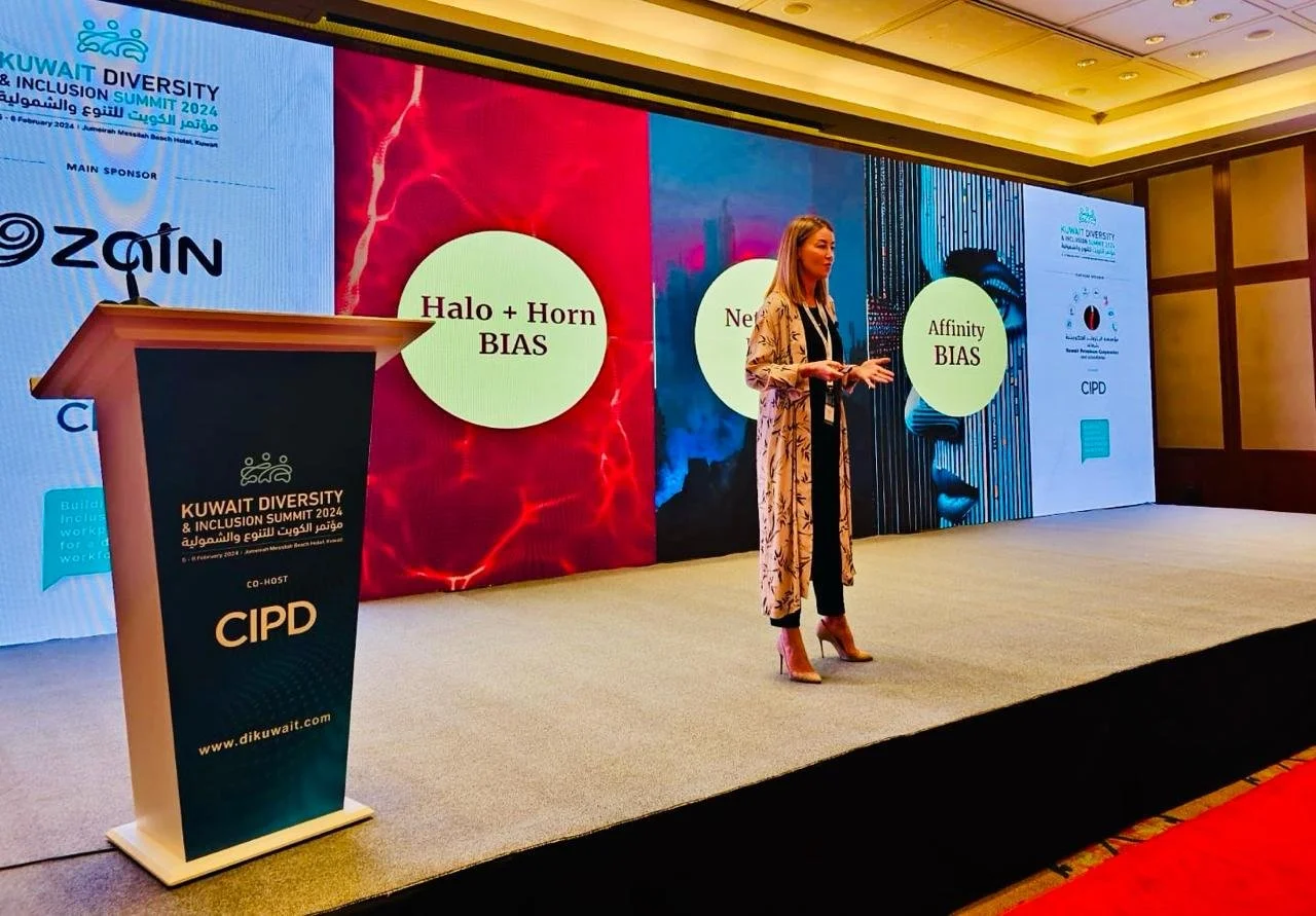 A photo of Helen publicly speaking on stage.