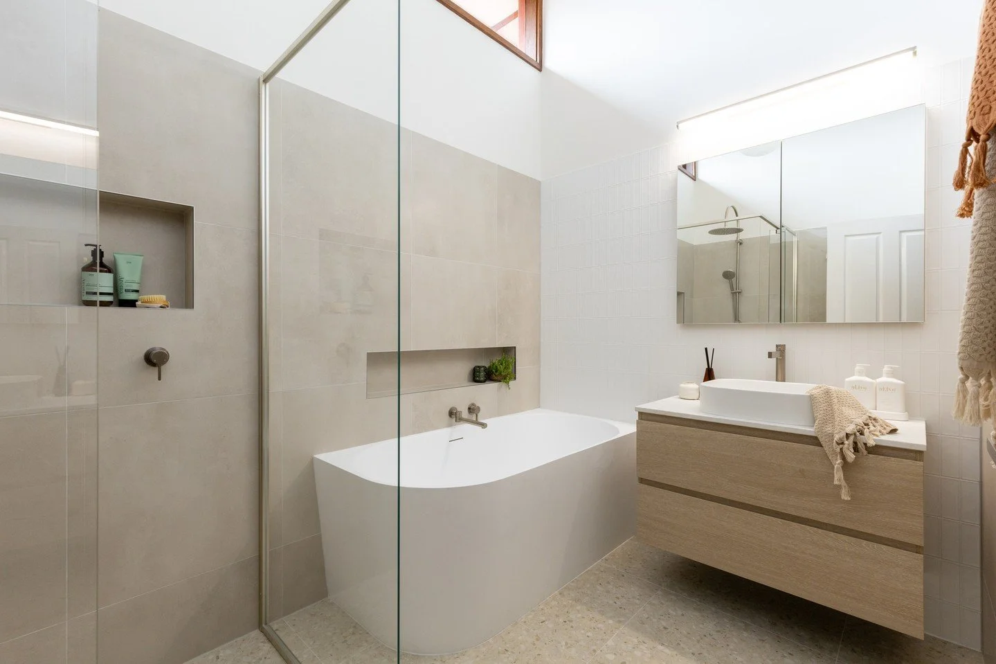 Before &amp; After / Greensborough⁠
⁠
This family bathroom already had incredible bones &mdash; a pitched roof and beautiful wall-to-wall highlight timber windows that filled the space with natural light. The brief was simple: refresh the dated blue 