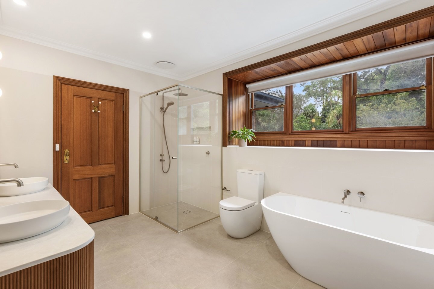 Family bathroom transformation💚

A calm, modern retreat designed for everyday living in this Eltham North project. Warm Florentine walnut cabinetry brings depth and cohesion, paired with soft stone-look flooring and light neutral wall tiles to creat