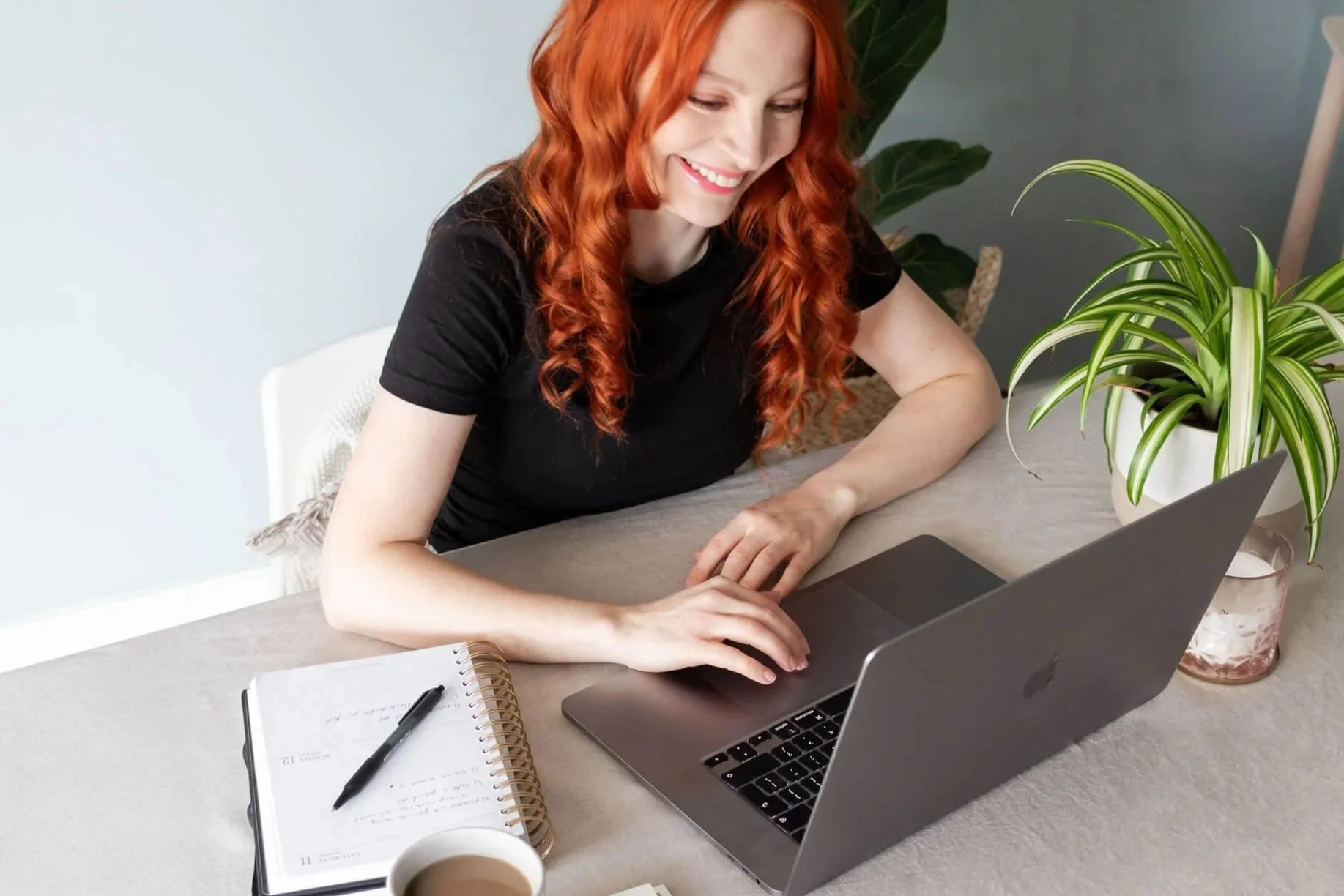 Freelance brand designer working on client brand identity at her desk.