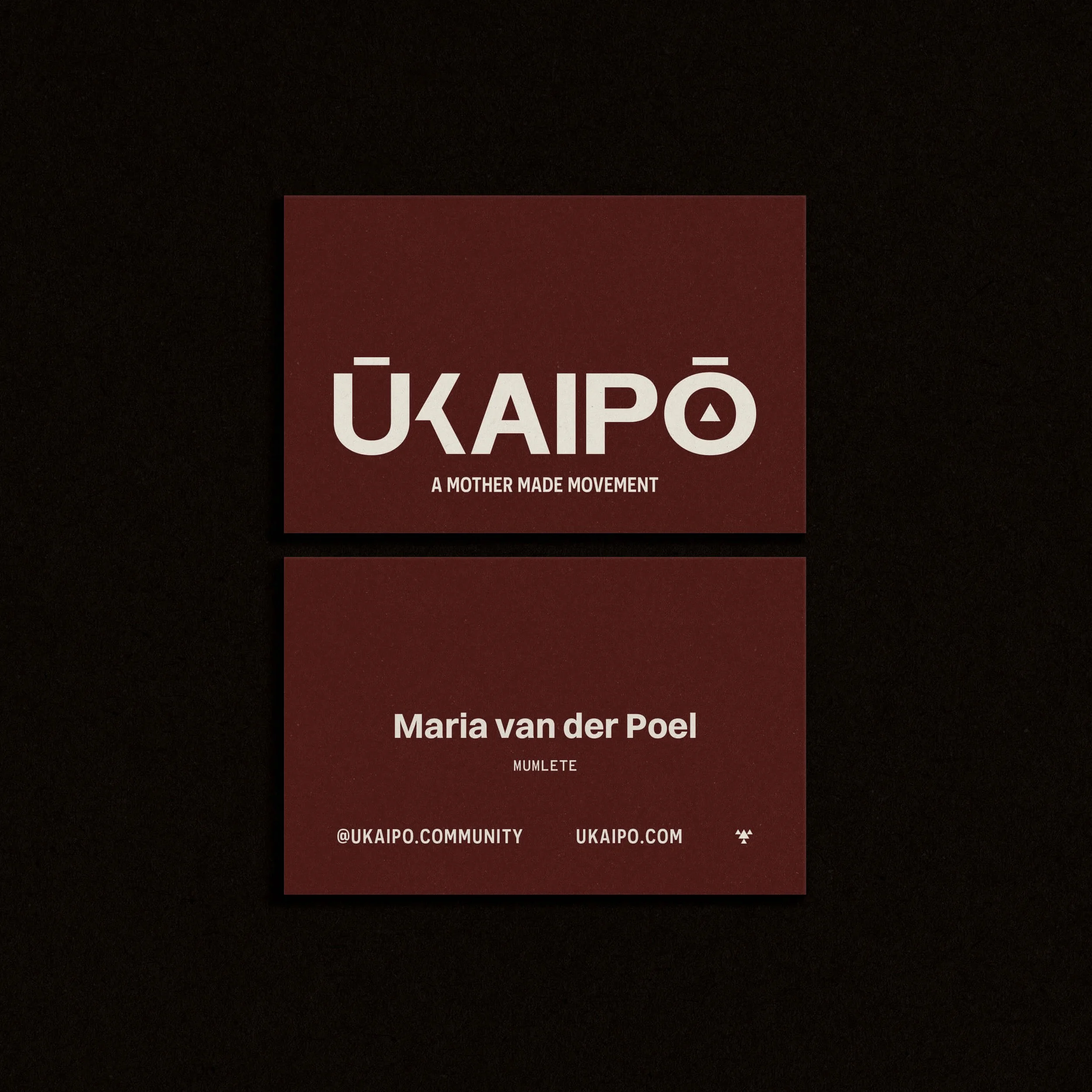 ŪKAIPŌ burgundy business cards with gold foil logo showing premium brand identity design.