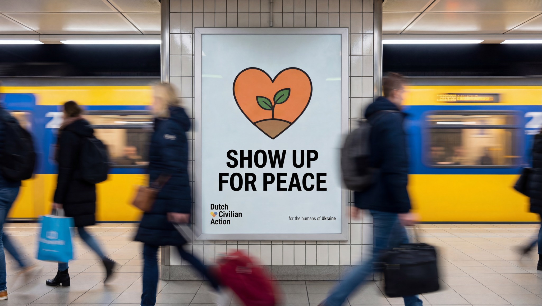 A subway station with a large poster on the wall featuring a heart-shaped outline with a sprouting plant inside, and the message "Show Up For Peace". People are walking past, some carrying bags and backpacks, with a yellow train in the background.