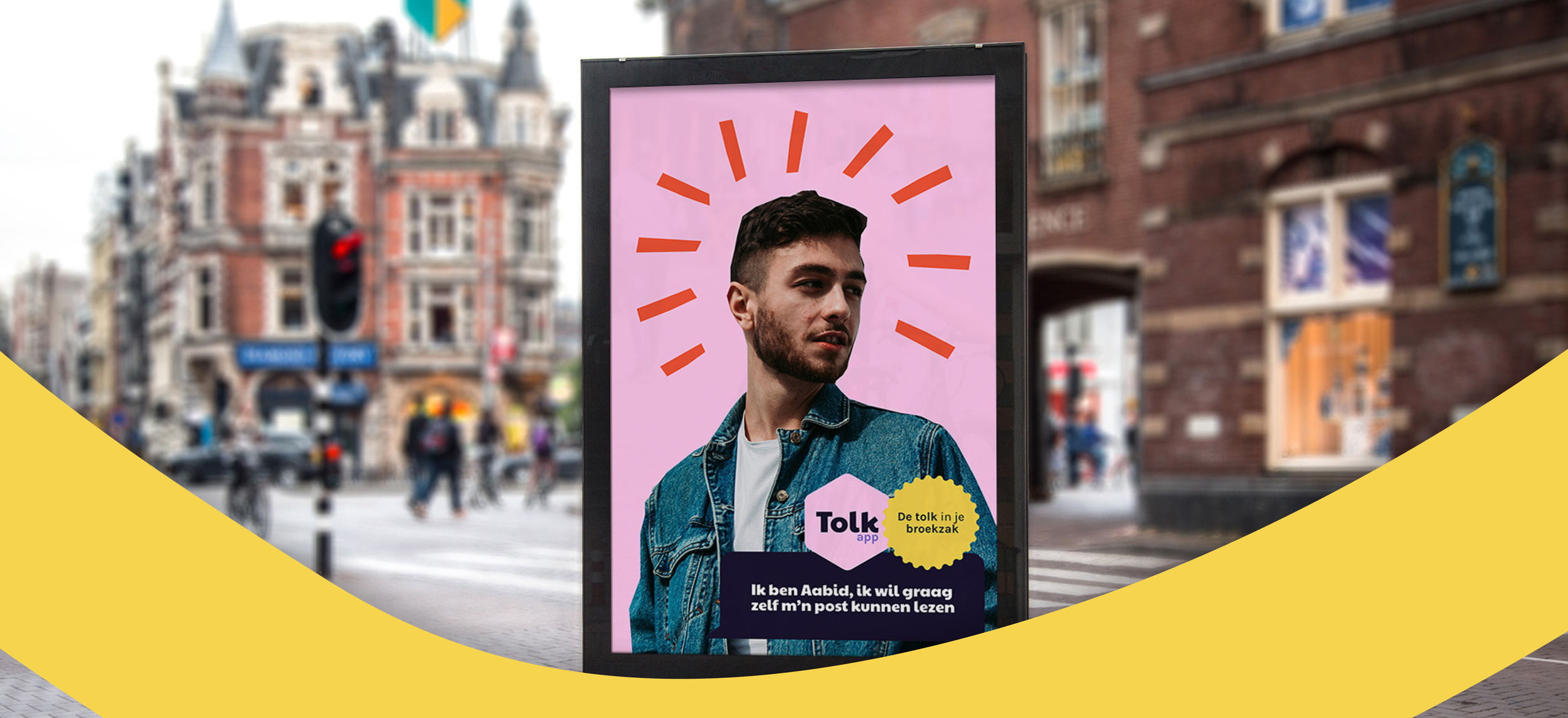 Street advertisement featuring a young man with a beard wearing a denim jacket, with graphic red lines radiating from his head, and text in Dutch about a translation app called Tolk.