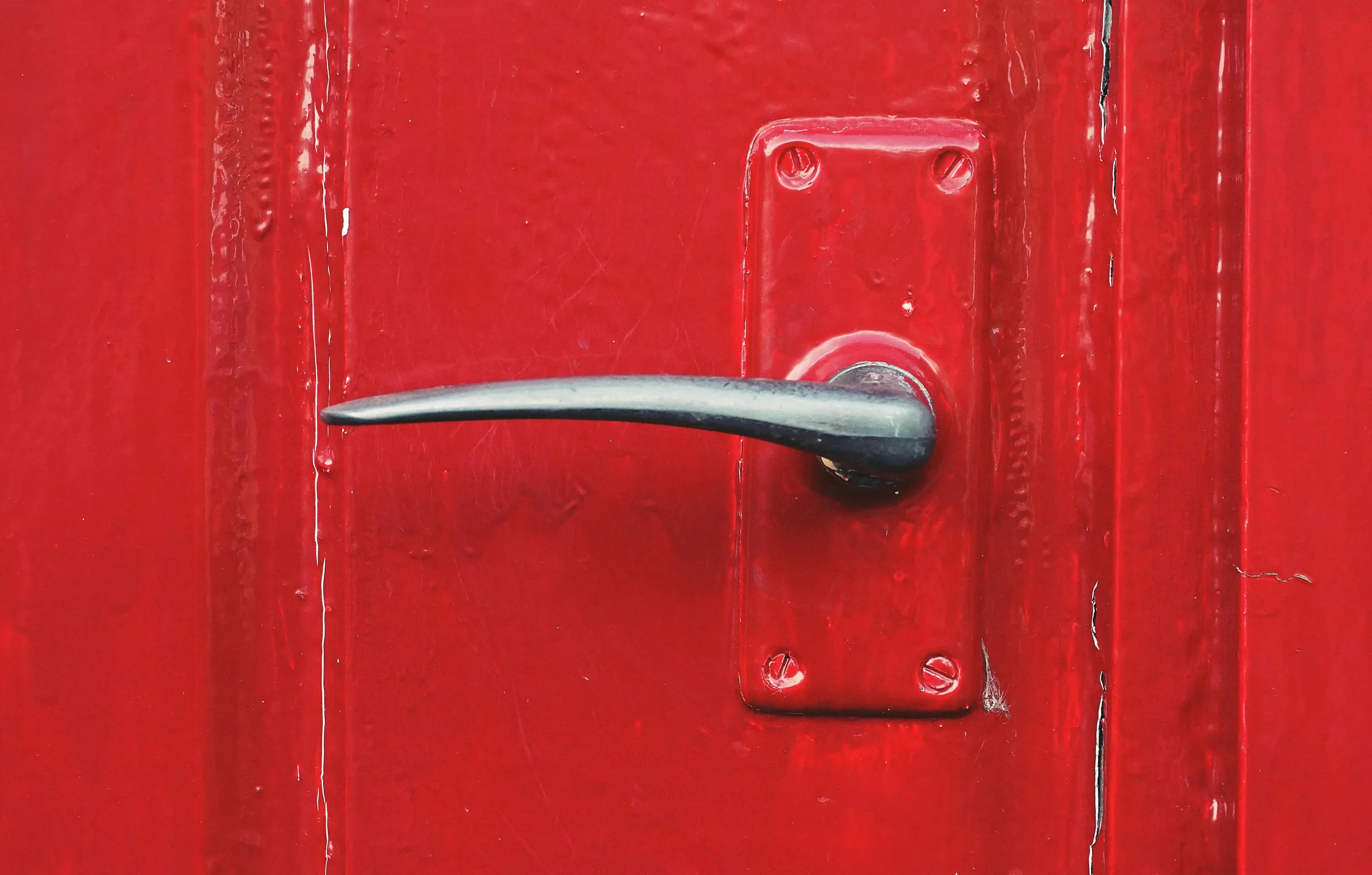 A close-up of a front door’s handle with the door painted red - Stephen Radl Painting