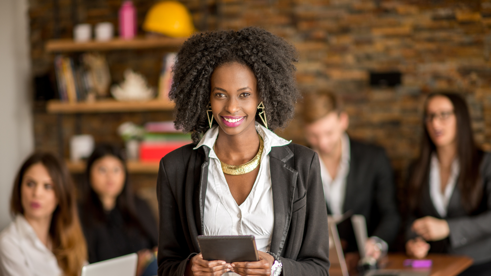 A confident black woman leading a meeting