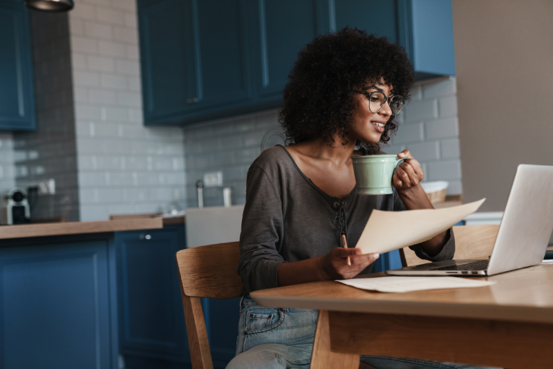 A woman working at a kitchen table