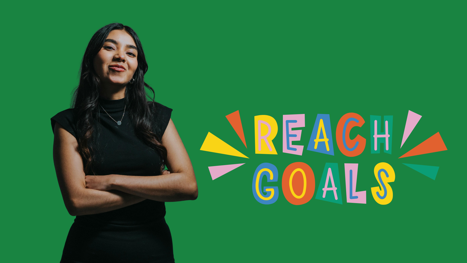 Confident woman standing with arms crossed beside colourful ‘Reach Goals’ text.