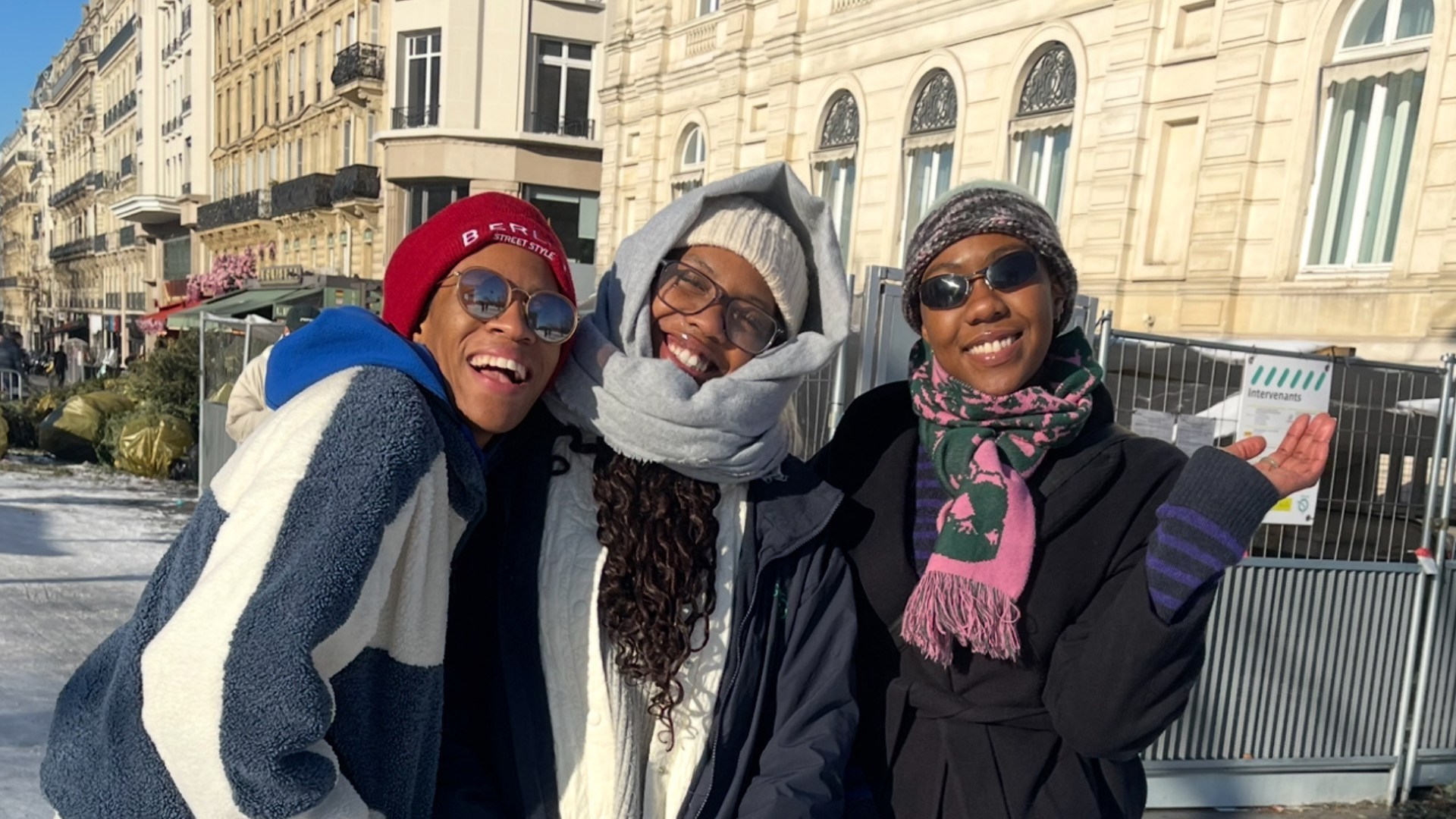 Three sisters with their arms linked together and smiling