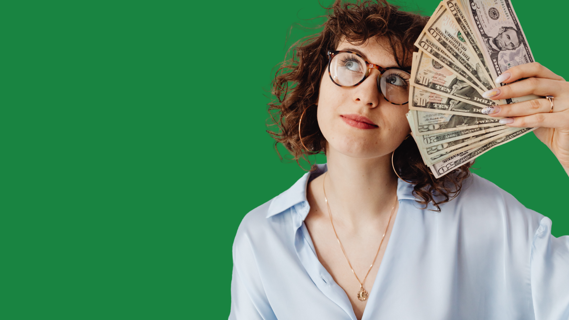 Woman holding a fan of banknotes
