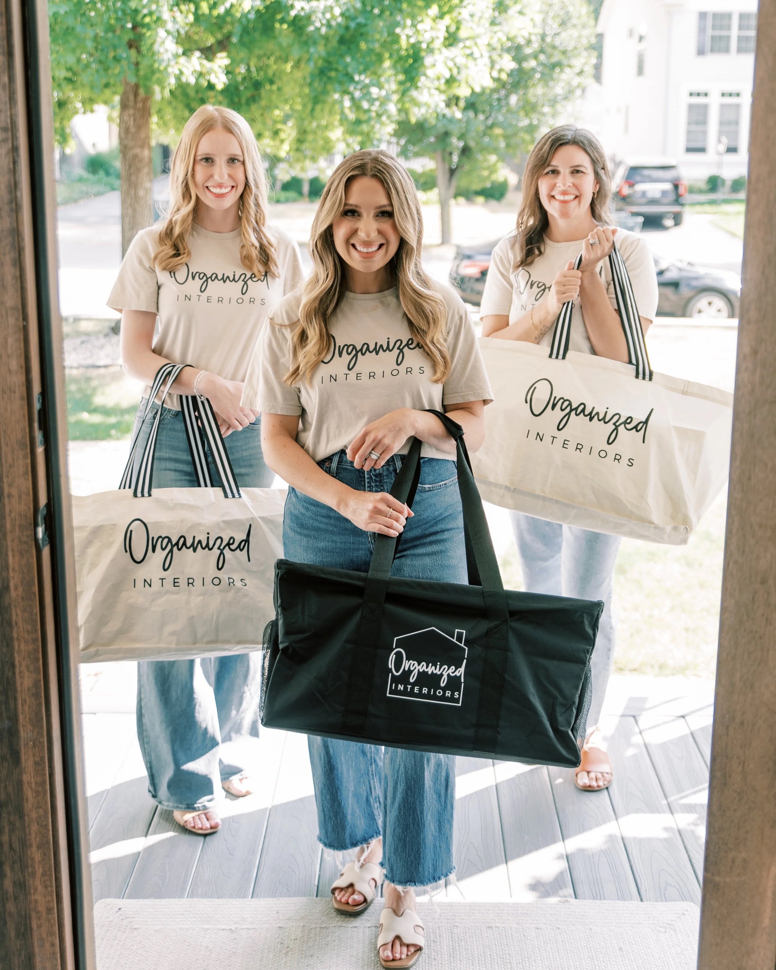 The Organized Interiors team arriving at a client's home with professional organizing supplies for a home organization project.