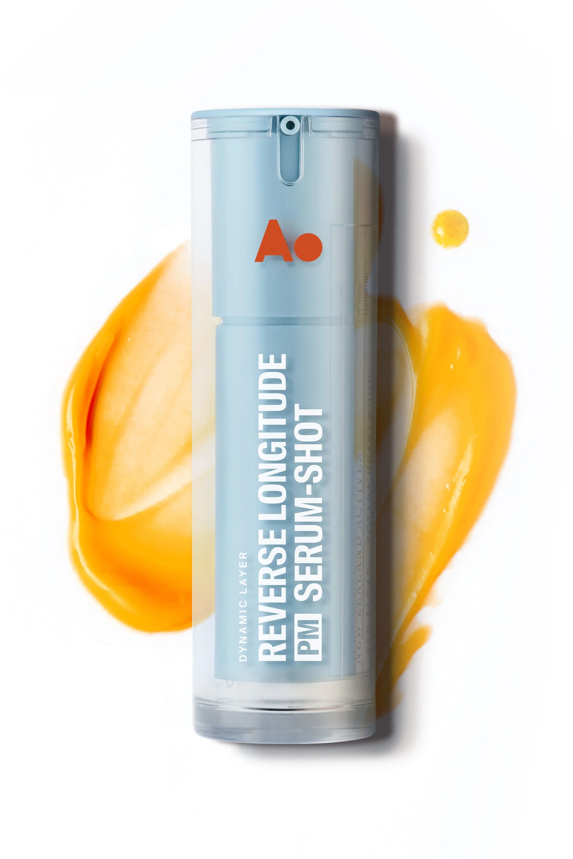 A spray can labeled 'Reversal Longitude PM Serum Long-Extra Shot' placed on a white surface with a piece of yellow mango and mango juice splashed around it.
