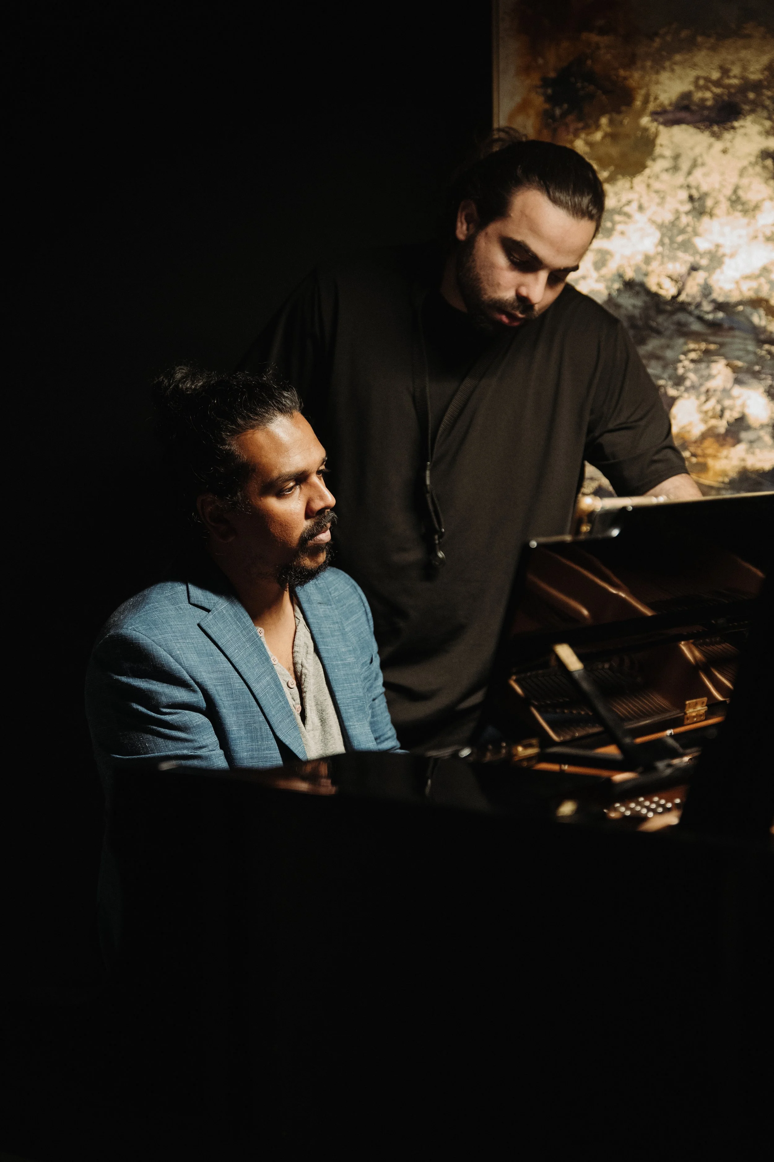 Piano lesson with instructor and student in a quiet home setting