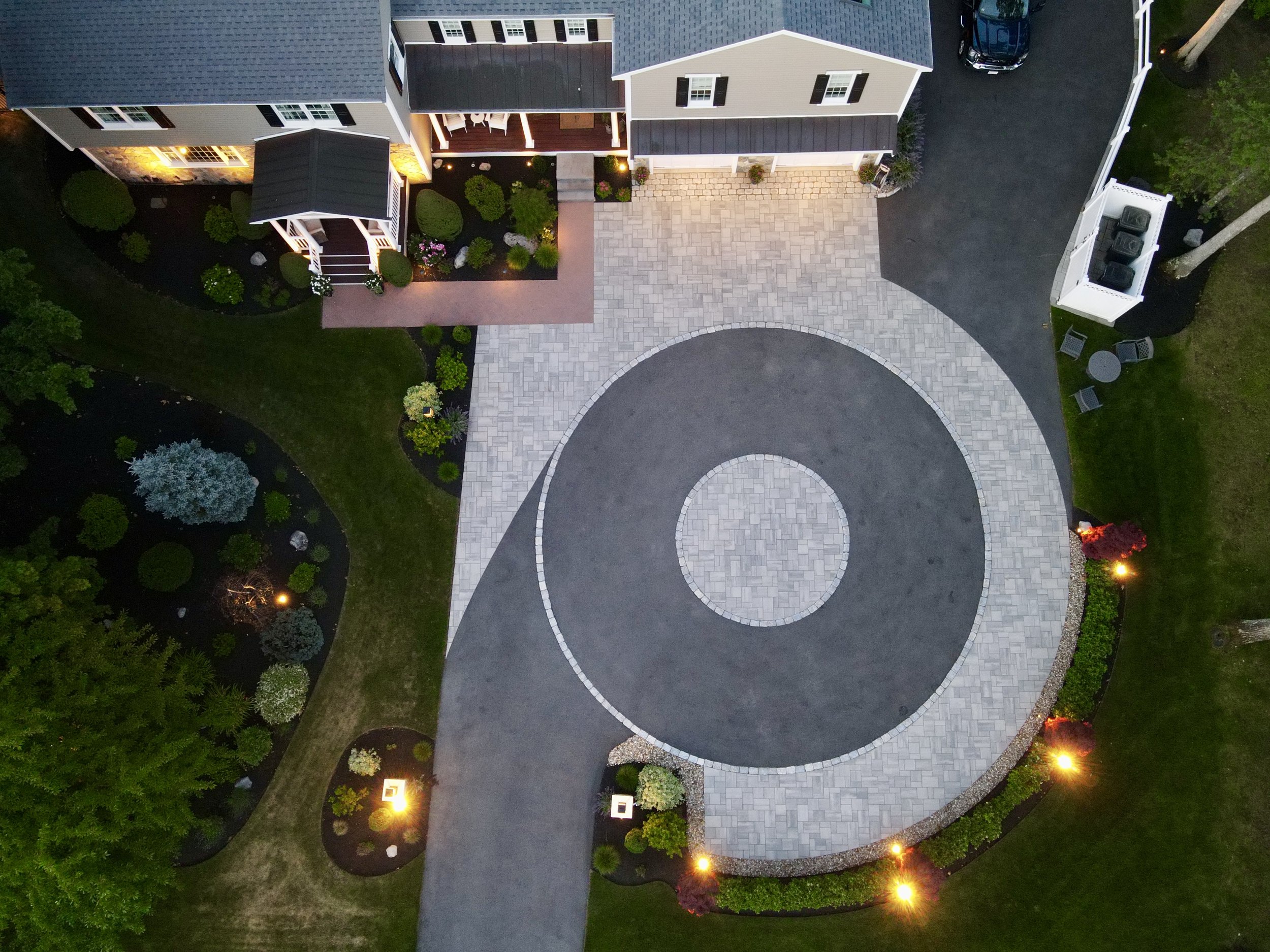 Front entrance lighting highlighting landscaping and architectural details of a Middleton, MA residence.