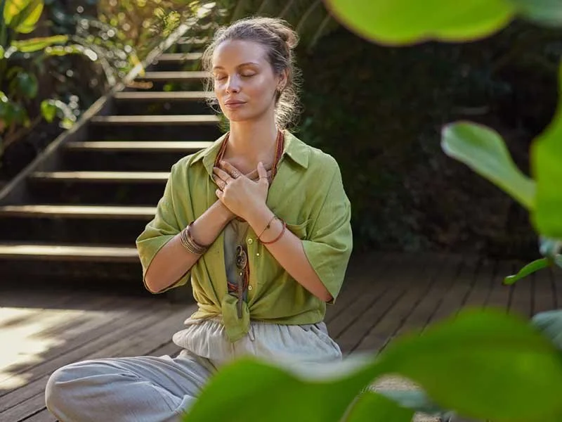 Woman with hands on her heart checking in with her emotions