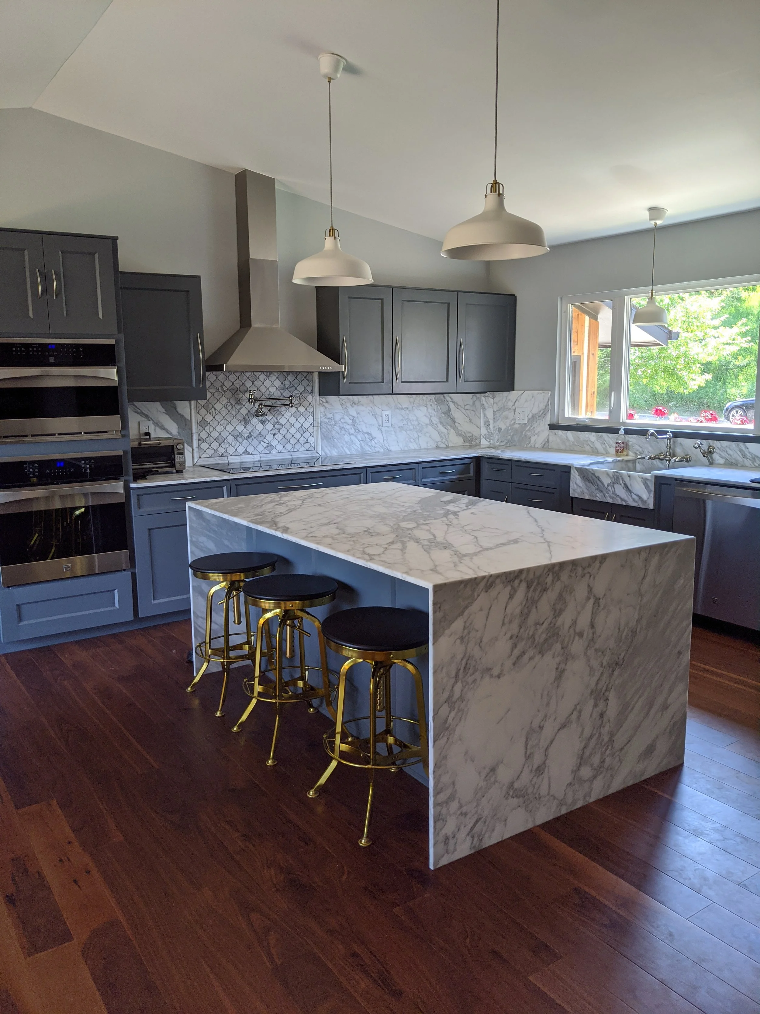 Marble kitchen with custom cabinets and facings.jpg