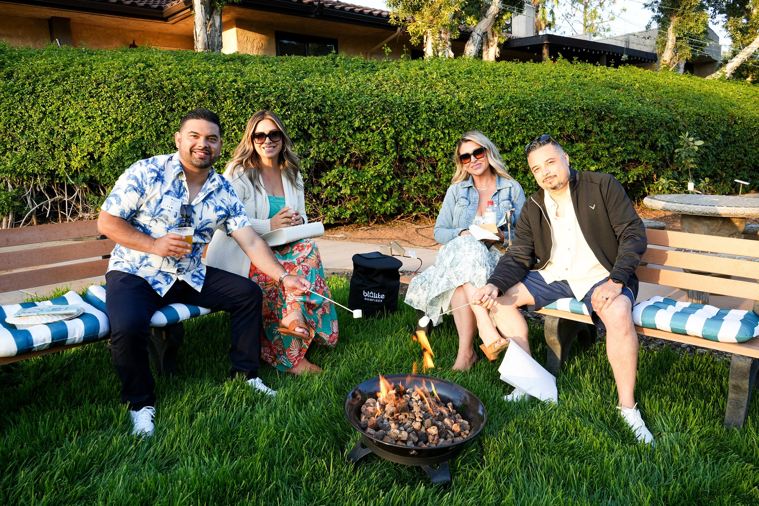 Group of people sitting around fire pit