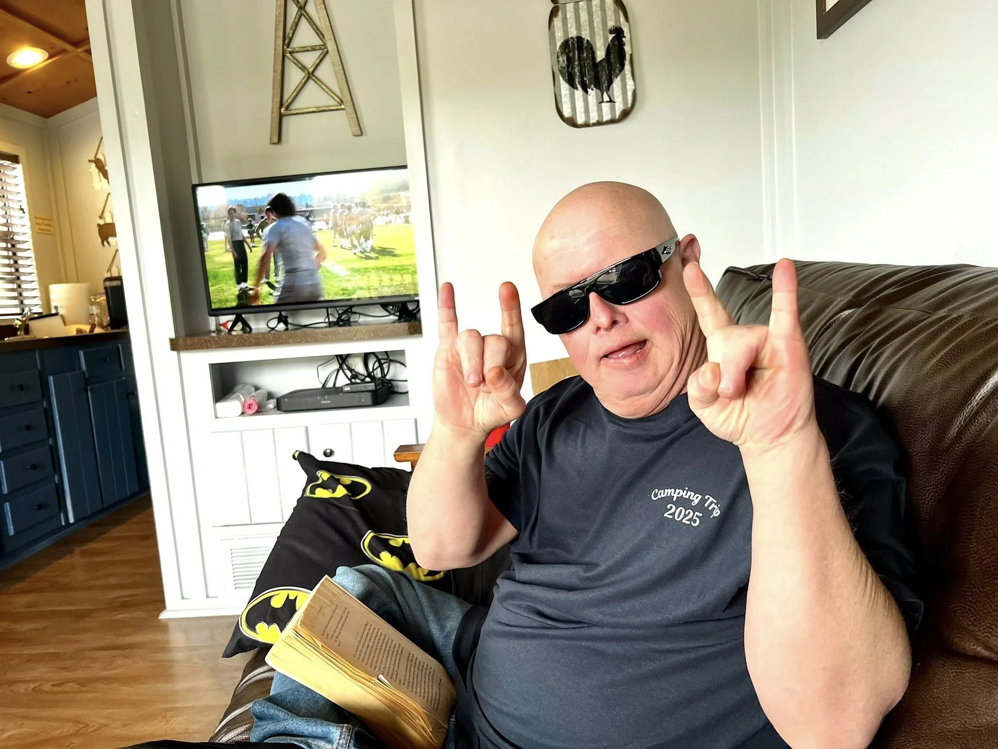Man with sunglasses doing rock and roll symbol