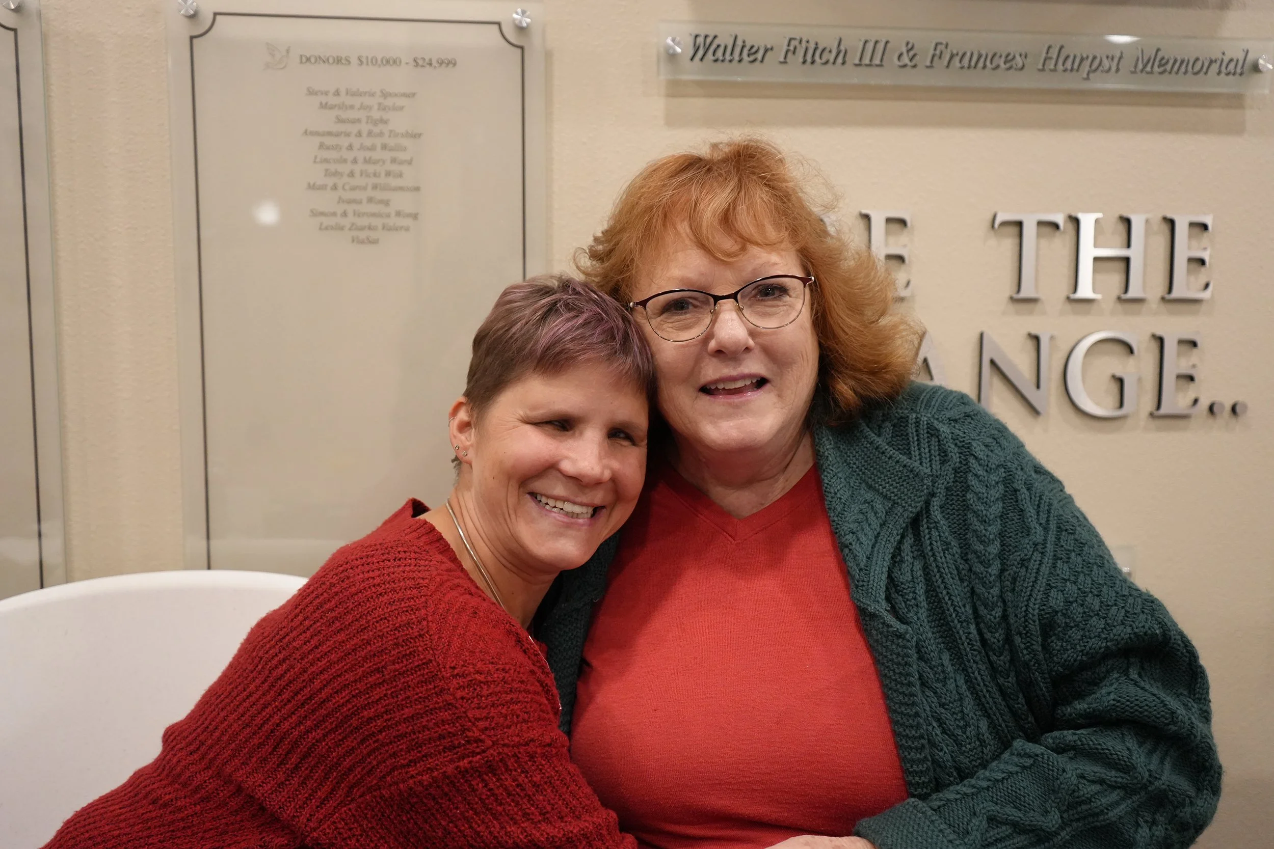 Two adults embrace one another