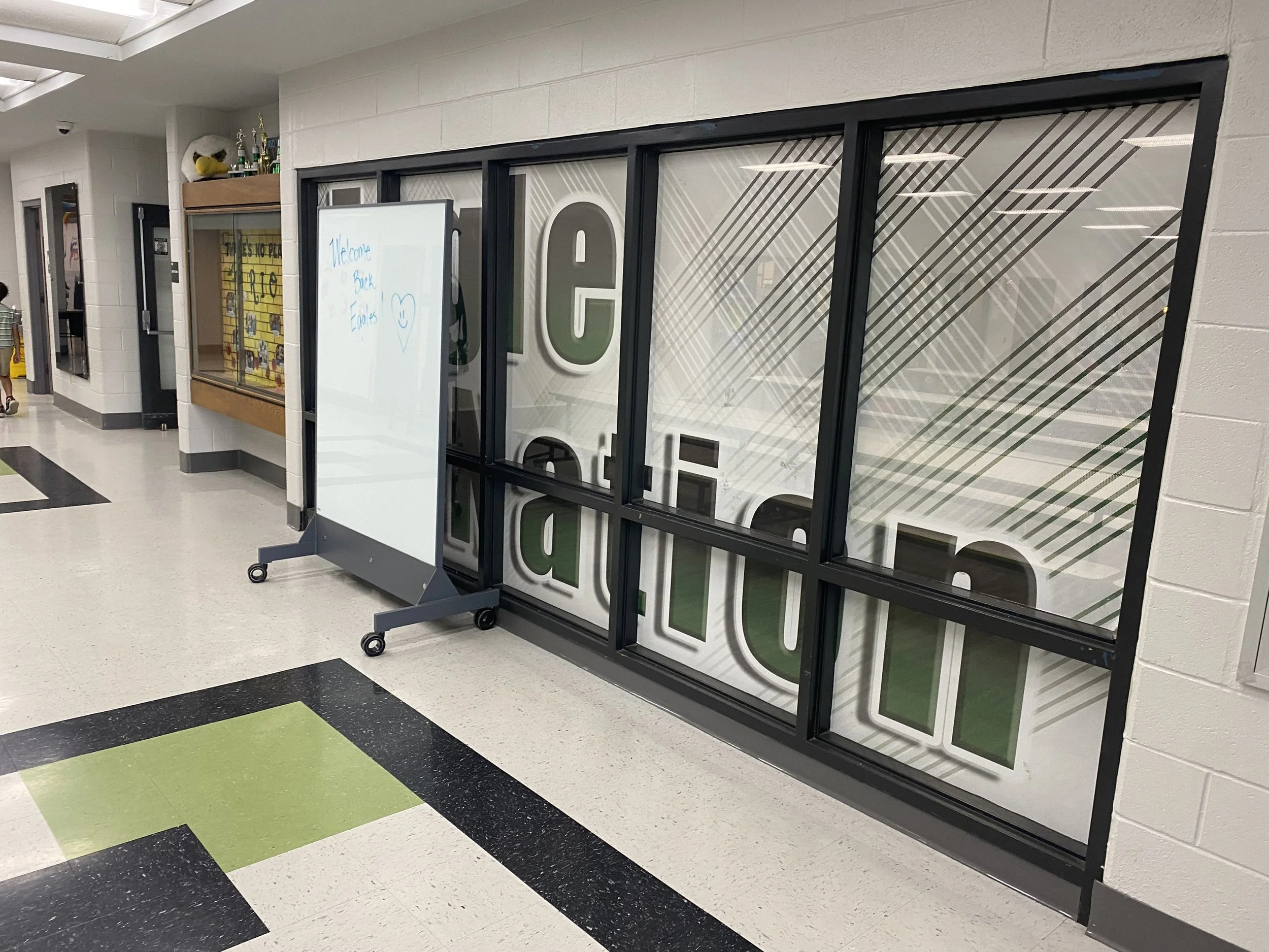 TAG Mobile bulletproof mobile whiteboard positioned in school hallway providing ballistic protection near cafeteria entrance