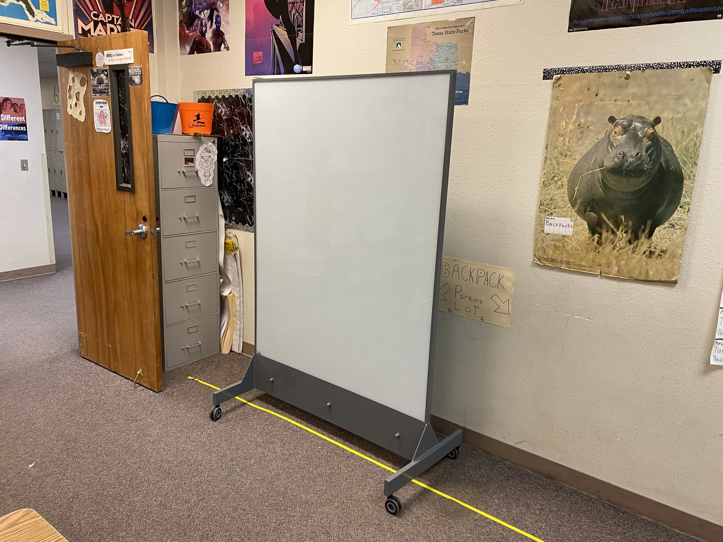 TAG Mobile bulletproof whiteboard positioned next to a classroom door for fast deployment during active shooter incidents