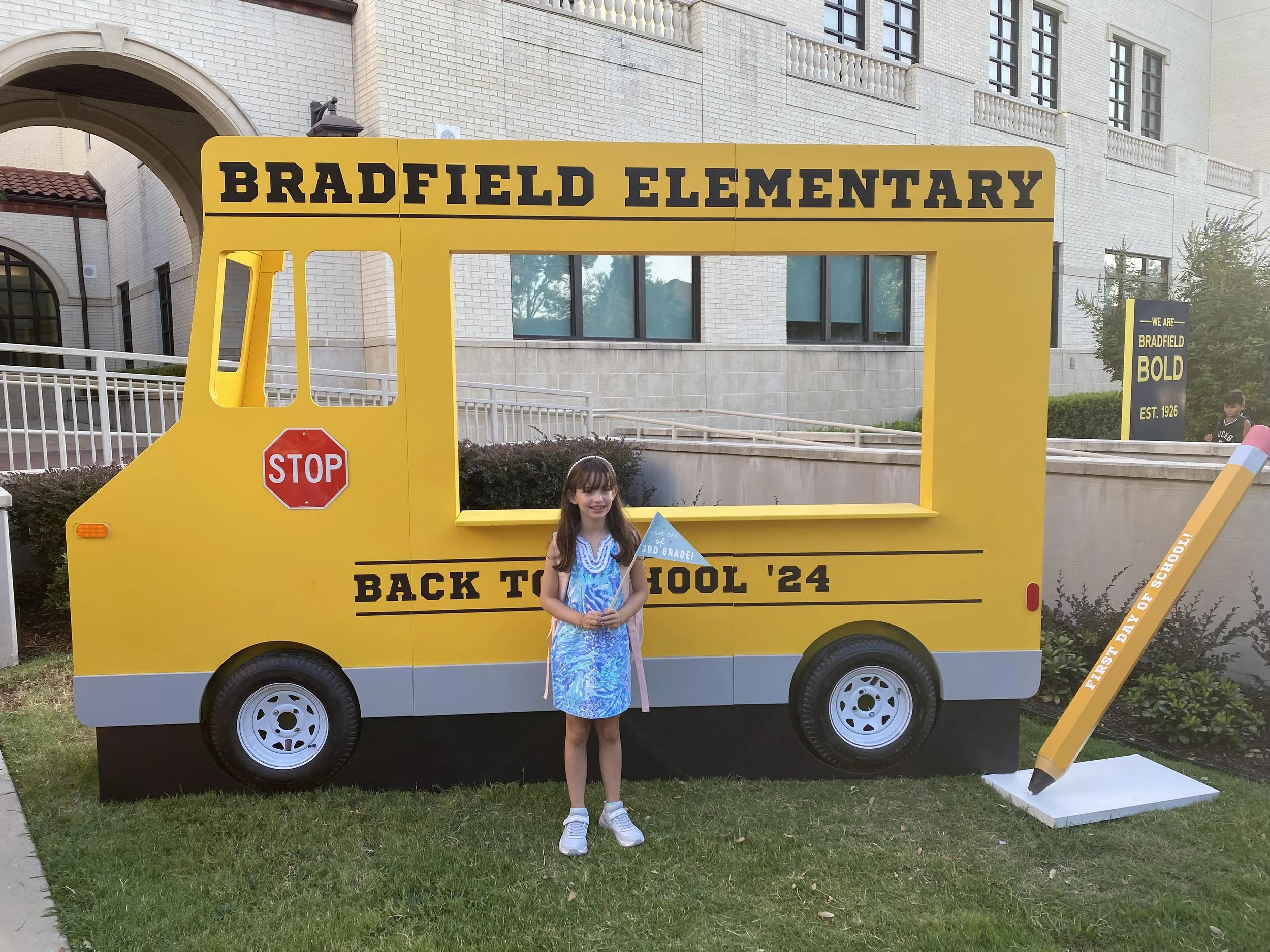 Student walking into school representing back-to-school safety, preparedness, and modern learning environments
