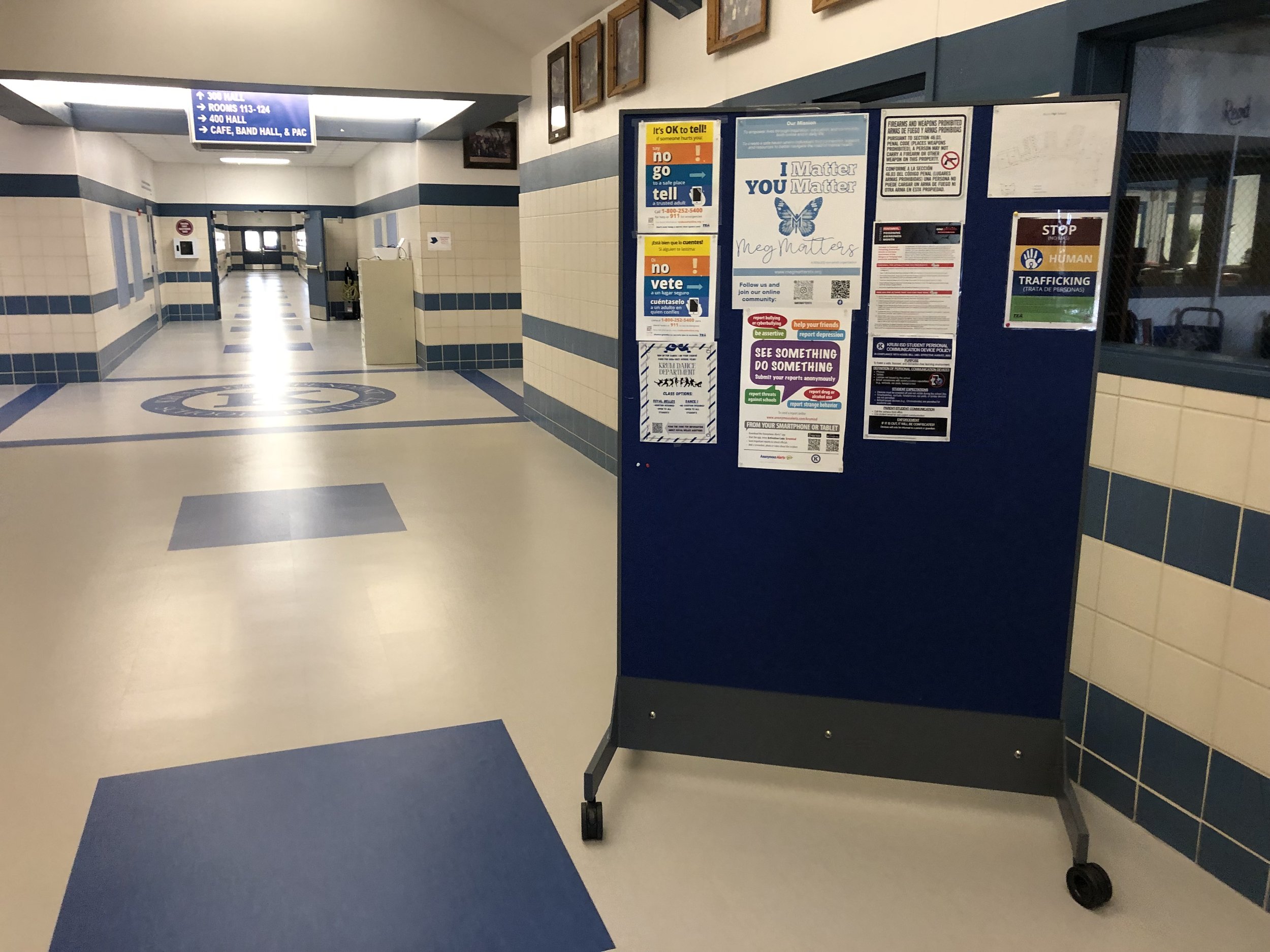 TAG Mobile™ bulletproof mobile whiteboard positioned in a school hallway using its acoustic panel for student communication while providing immediately accessible ballistic protection as part of a layered school security strategy.