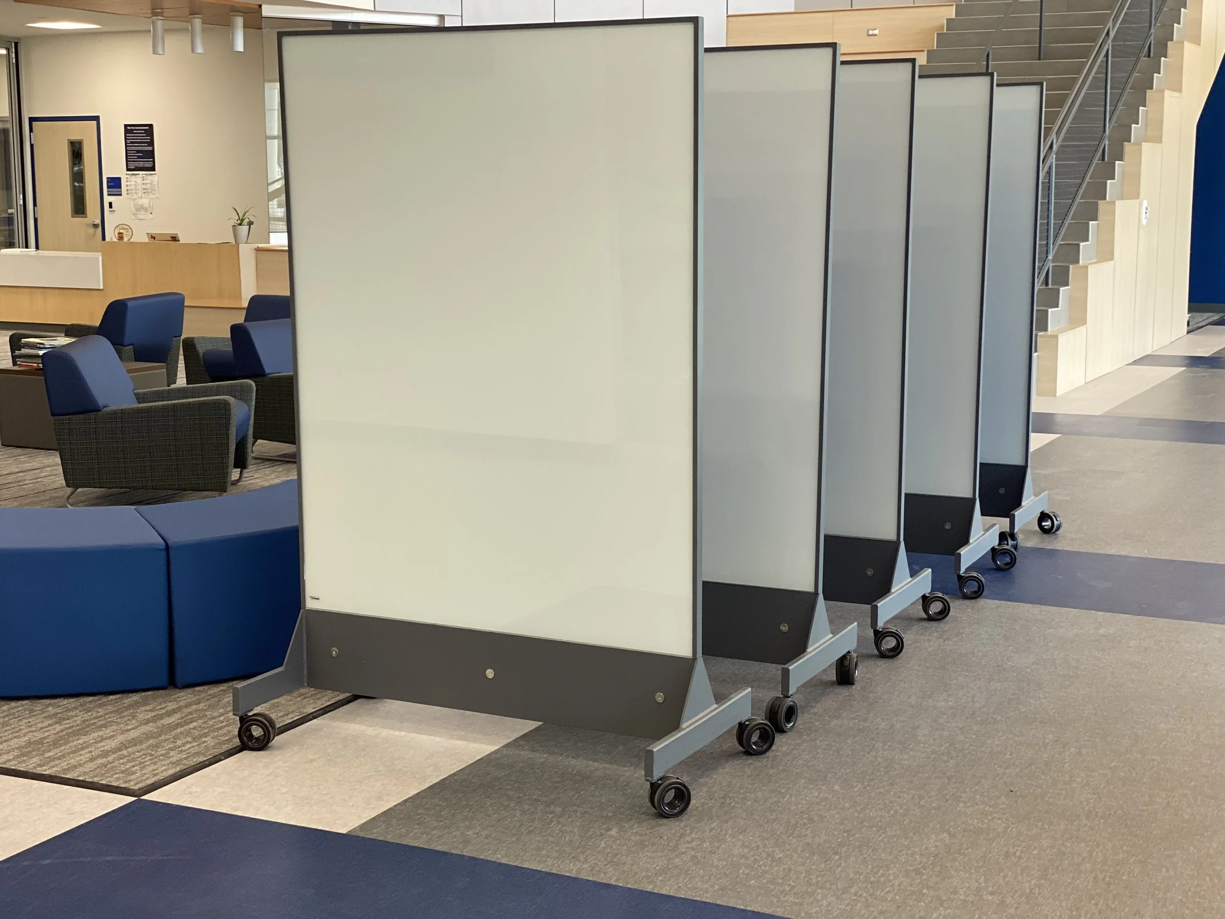 TAG Mobile bulletproof mobile whiteboard units positioned in a school common area