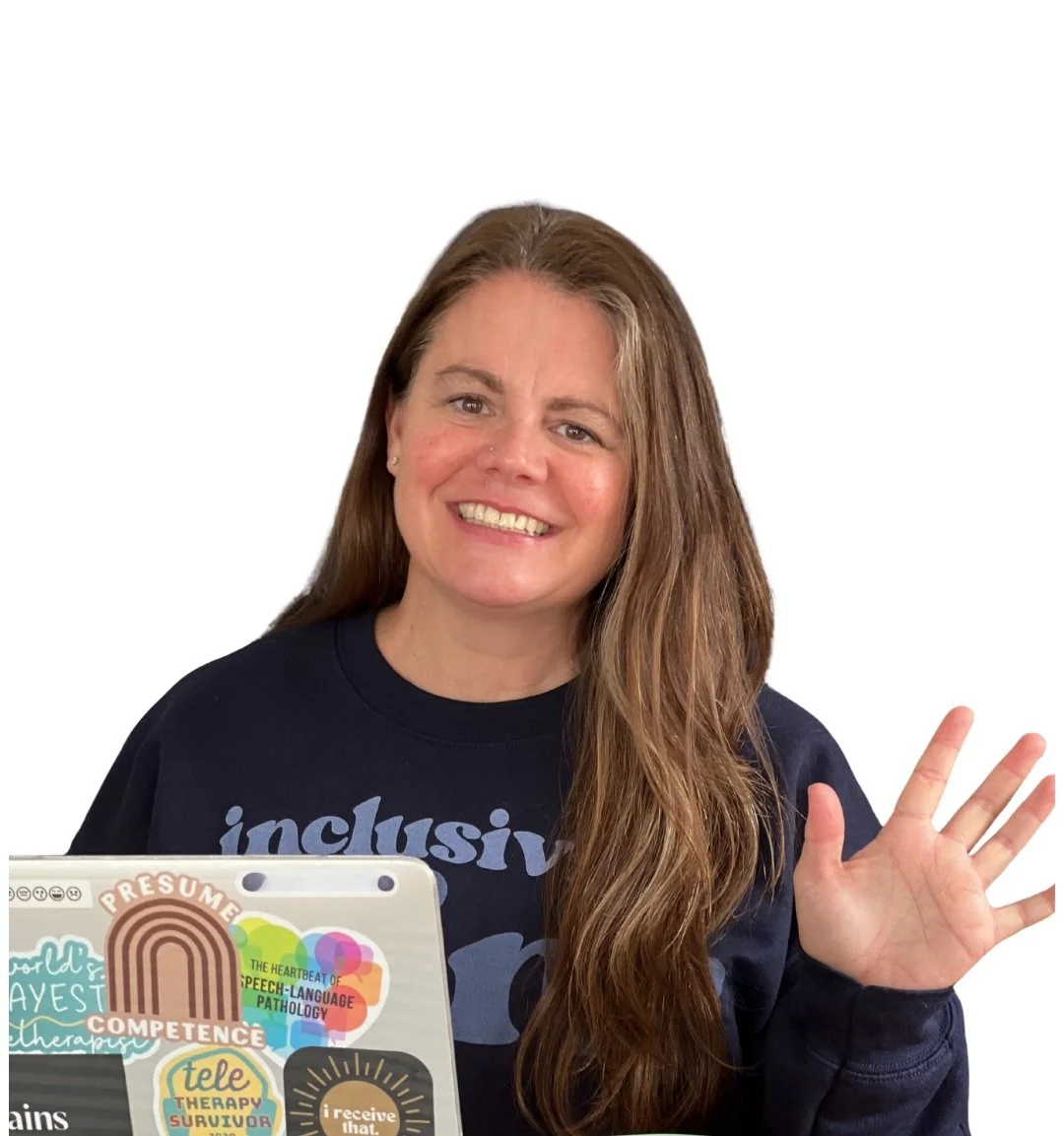 A woman with long brown hair smiling and waving, wearing a navy sweatshirt with partially visible text, seated in front of a laptop covered with various colorful stickers.