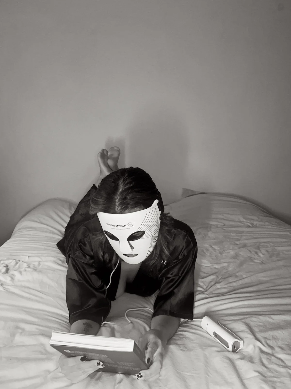 woman wearing a red light face mask