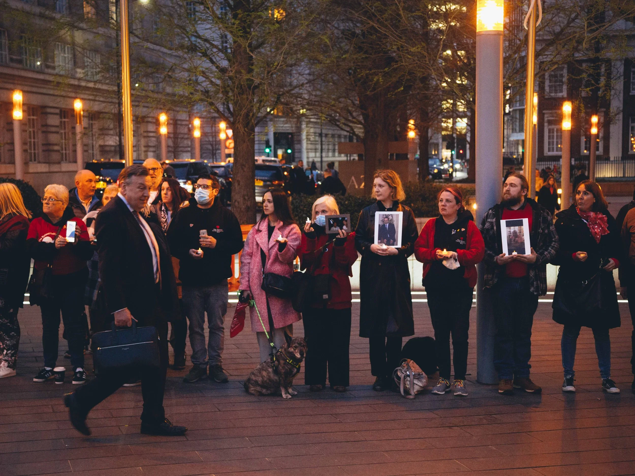 CBFJ members outside the Covid Inquiry holding photographs of loved ones