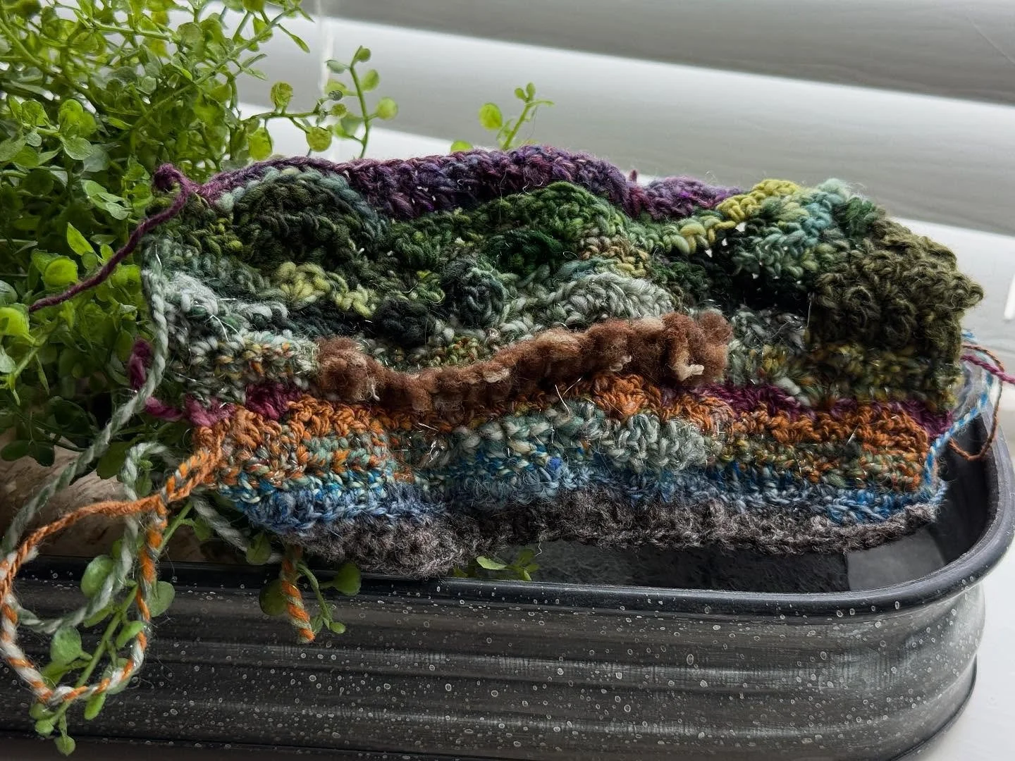 When I leave the house, I usually carry a bag filled with tiny balls of hand spun yarn, a crochet hook and a pair of snips because I never know when art will want to come to life.