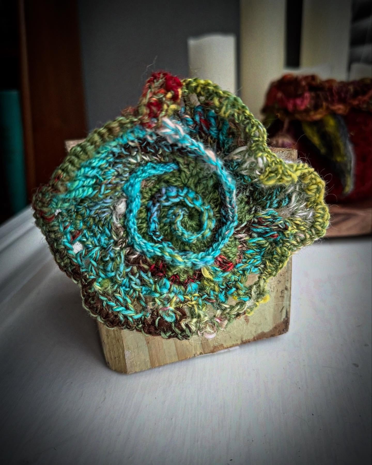 &ldquo;Wild Scrumble&rdquo; 

This little piece of art was crocheted from one hank of yarn that I spindle spun then plied into a textured lace weight yarn full of life, color and texture. 

When I crochet like this, I follow the yarn, changing stitch