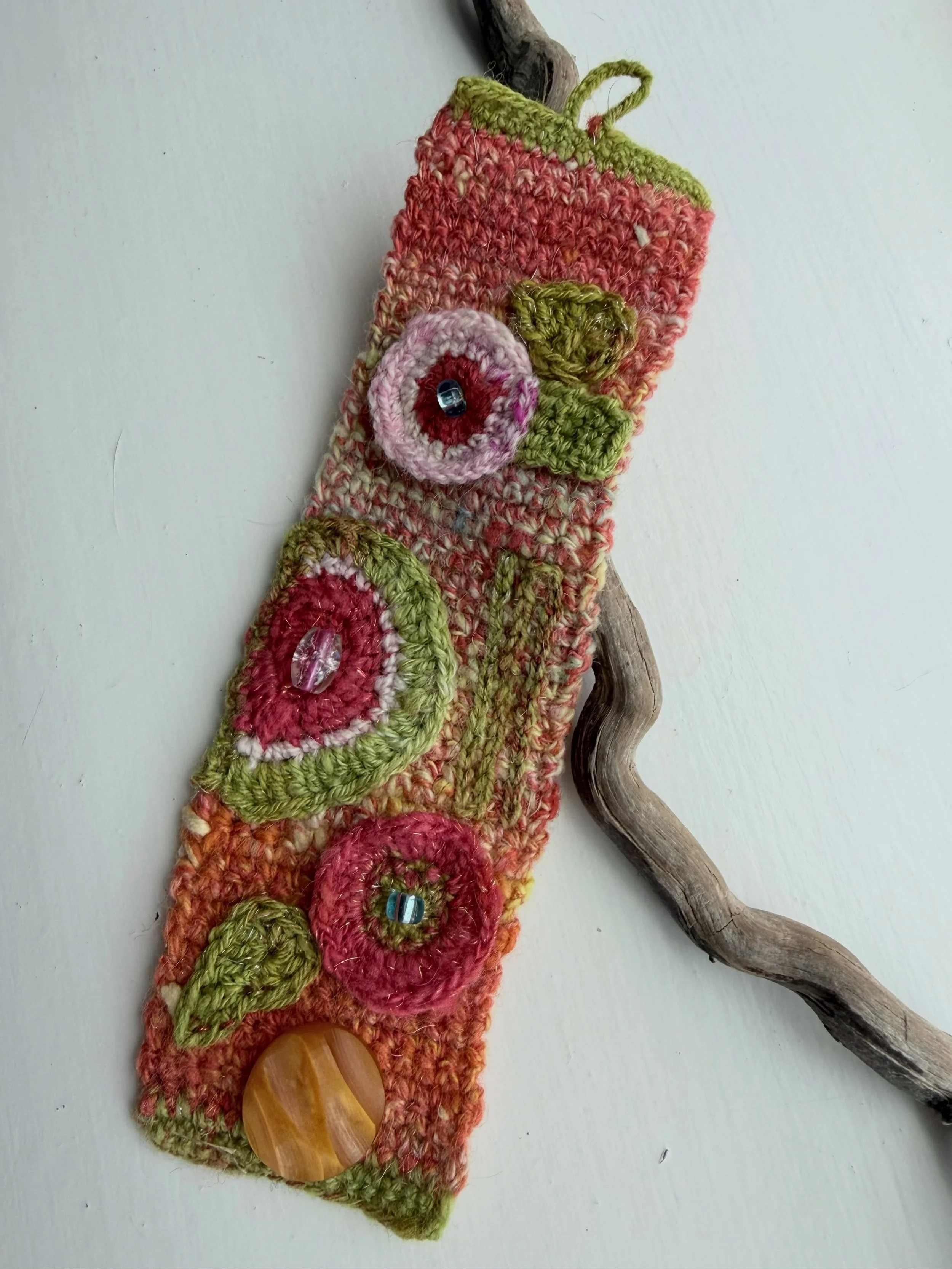 I posted a tease of this bracelet when I finished it. Now that it has been gifted, I can share the full view. I am in my &lsquo;Crochet Flower Power&rsquo; era. I love all the modern abstract style flowers I can think up. 

The base is single crochet