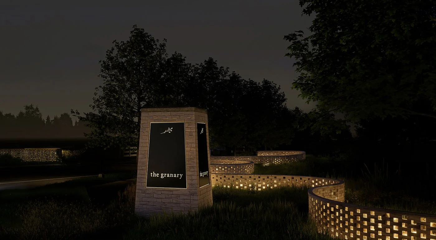 Nighttime rendering of The Granary monument sign with backlit panels and illuminated perforated brick walls along the entry landscape.