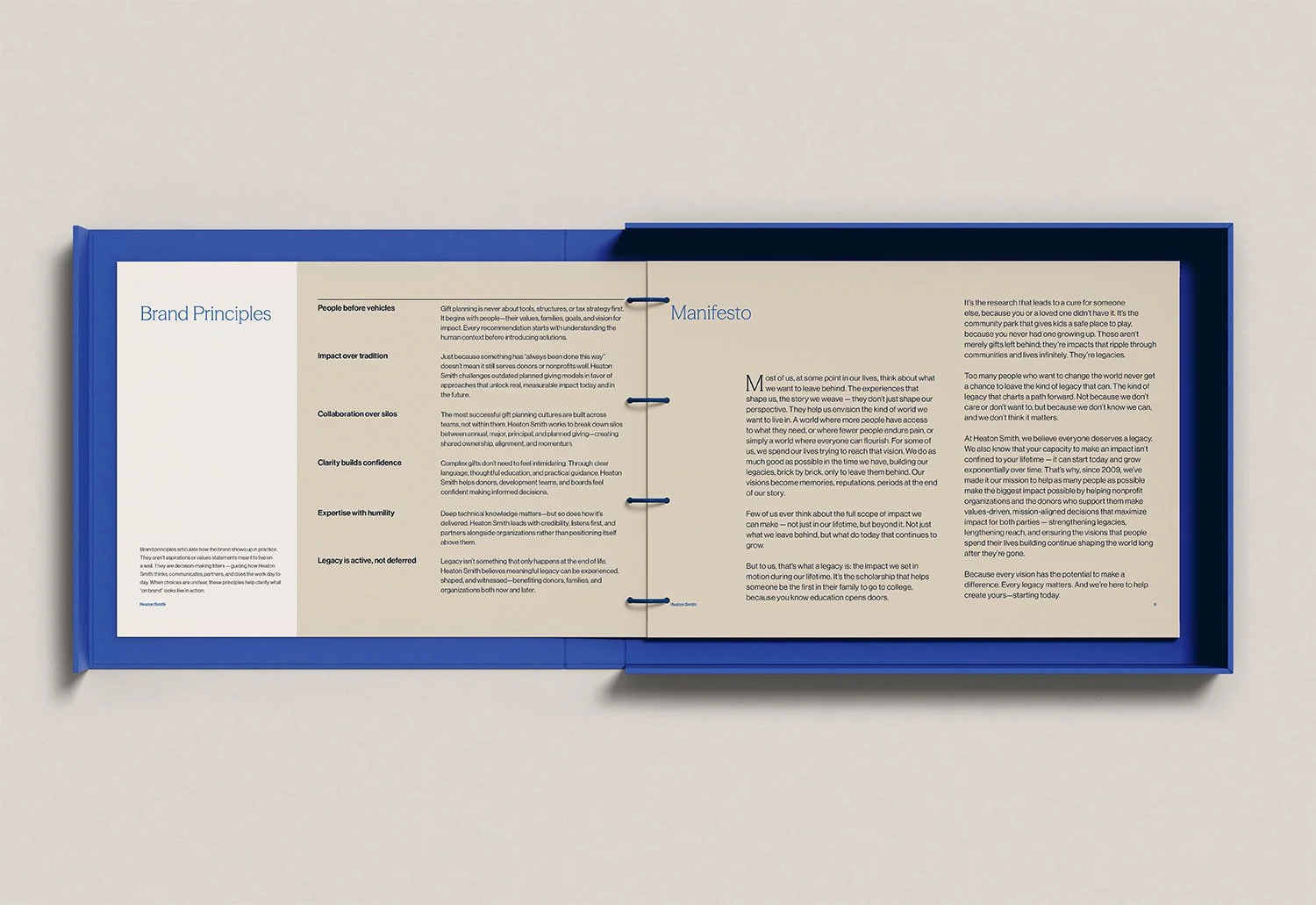 Open brand booklet showing the Heaton Smith manifesto and brand principles as part of the identity system.