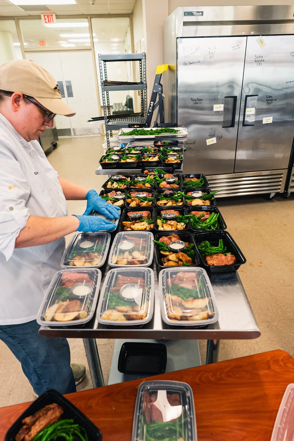 Coalition Kitchen chef packaging fresh prepared meals