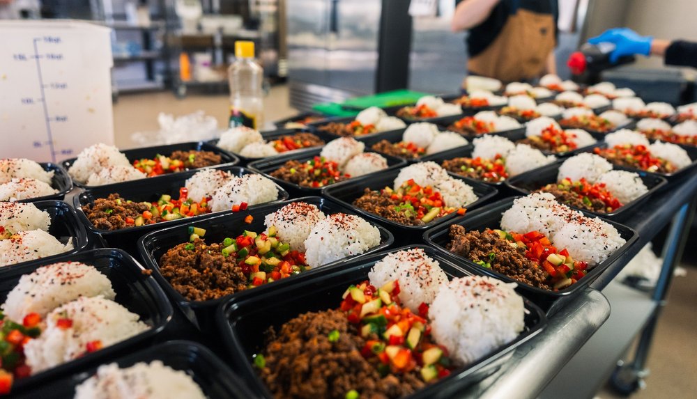 Coalition Kitchen meal prep with ground beef, rice and fresh vegetables