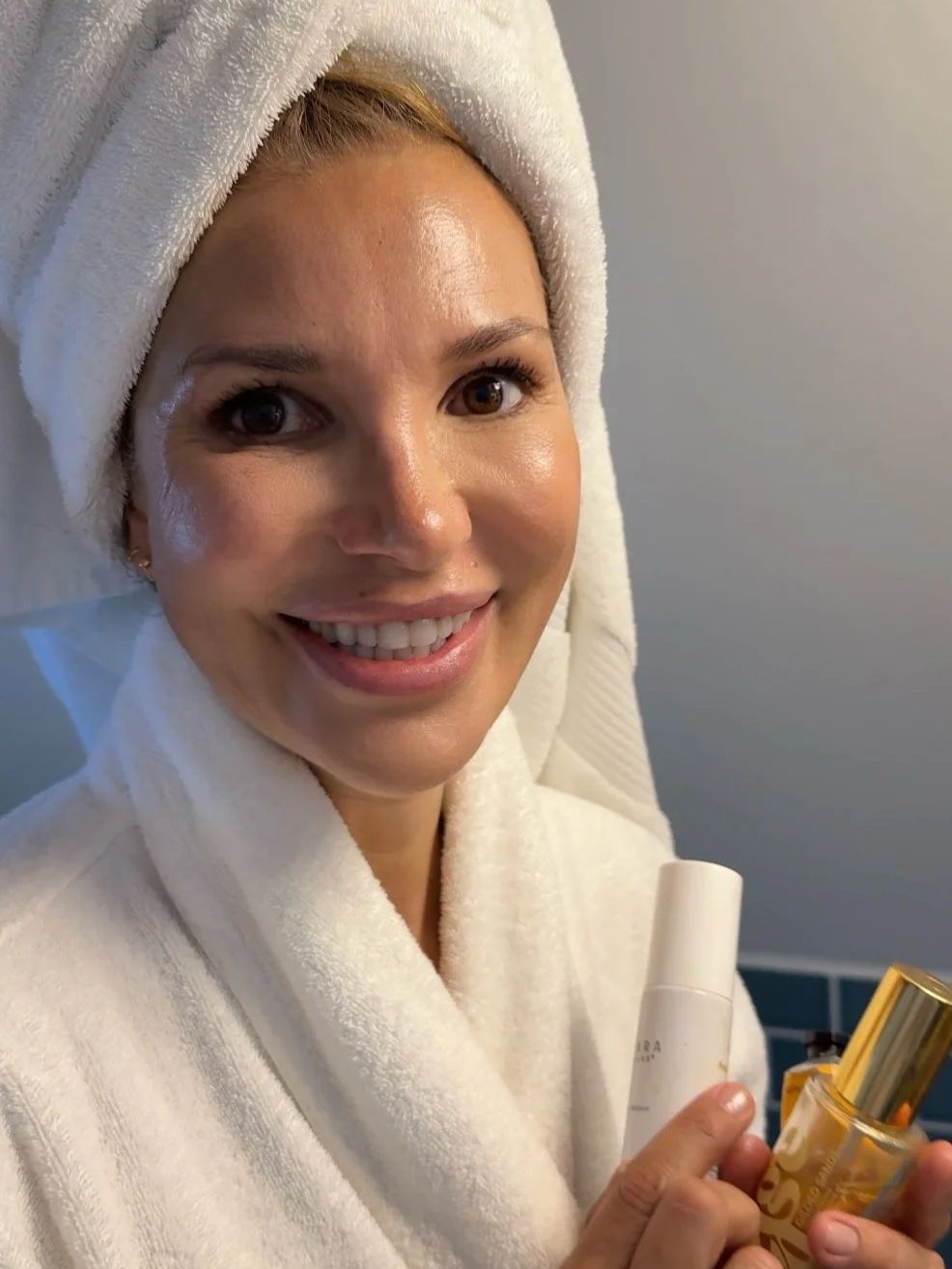 Anna Nenoiu morning skincare routine holding Vintage Noon SPF serum and body oil — The Beauty Confidante