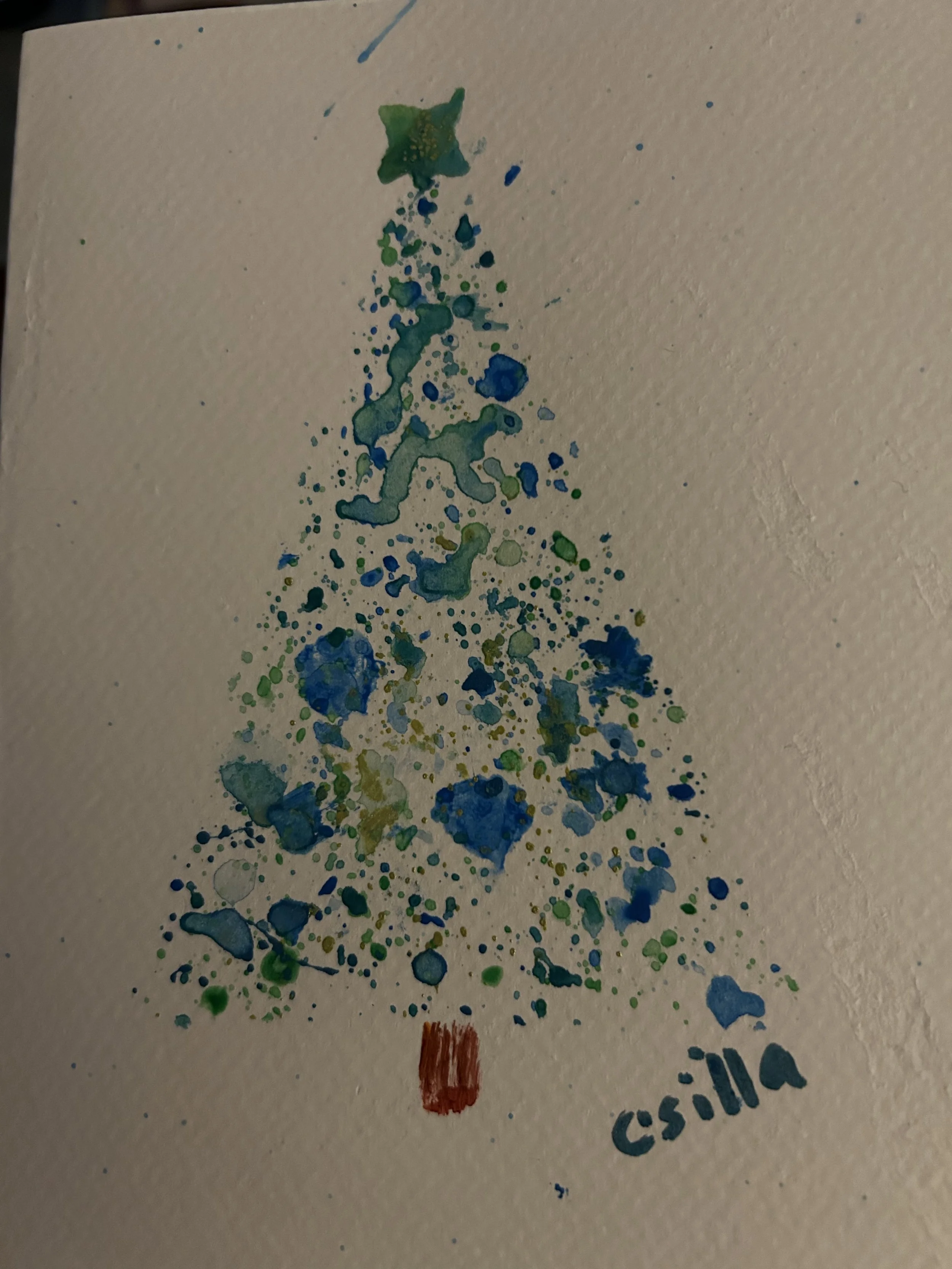 Watercolor painting of a Christmas tree with a star on top, decorated with green and blue paint splatters, signed by Csilla at the bottom.
