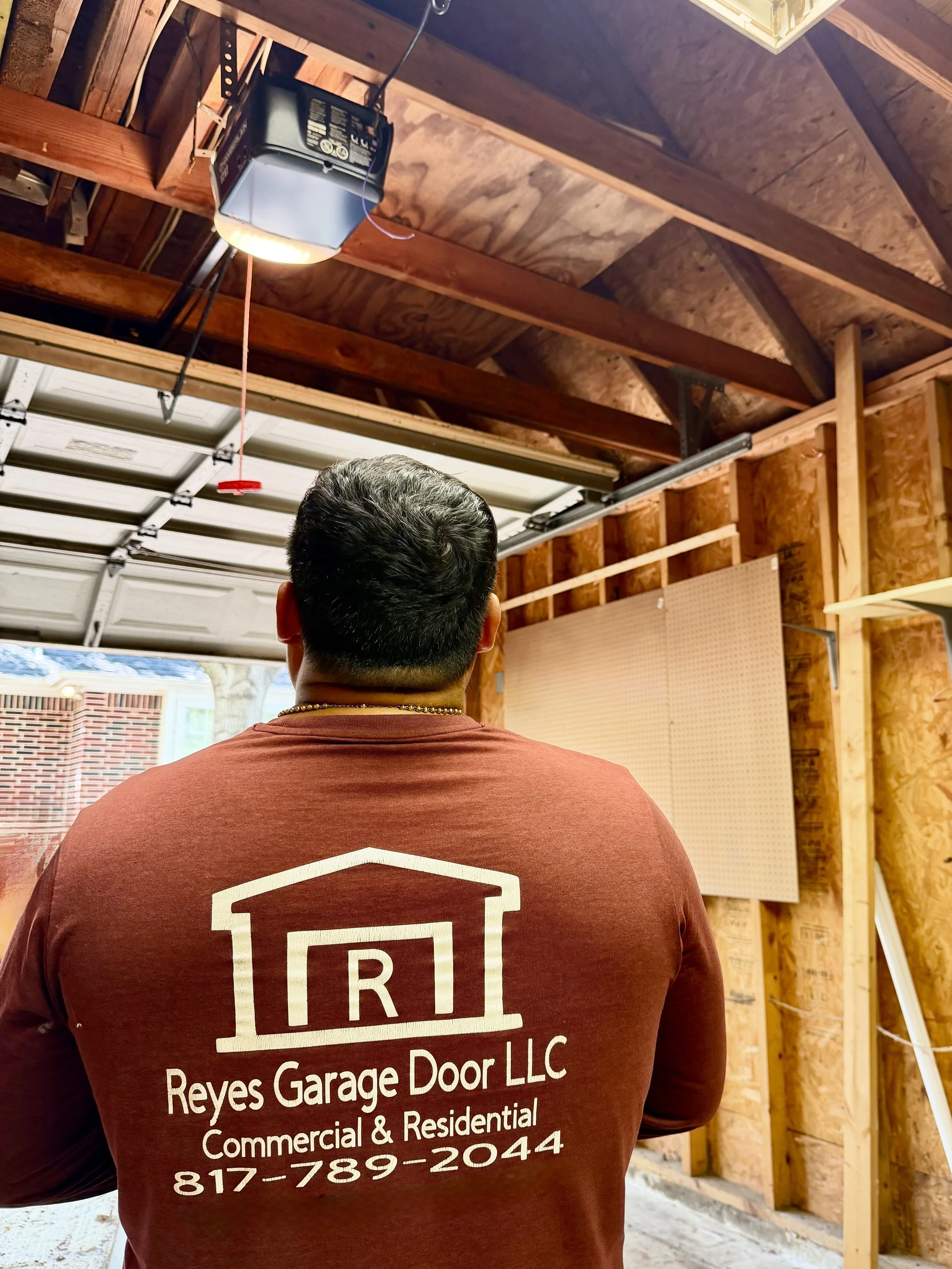 Reyes Garage Door technician performing garage door repair in DFW