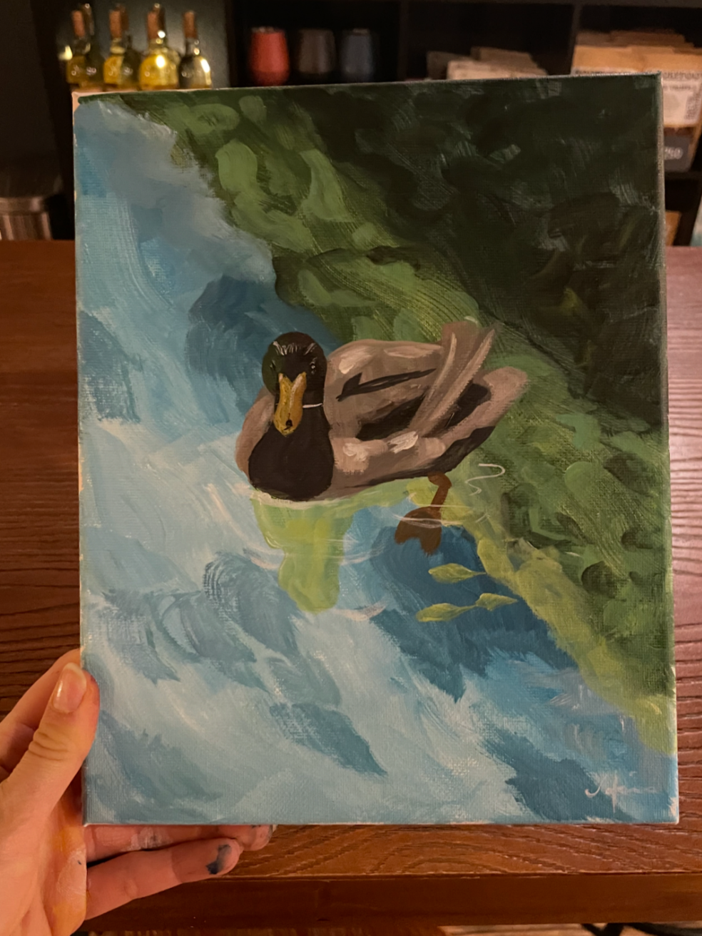 A painting of a duck swimming in water with green foliage in the background.