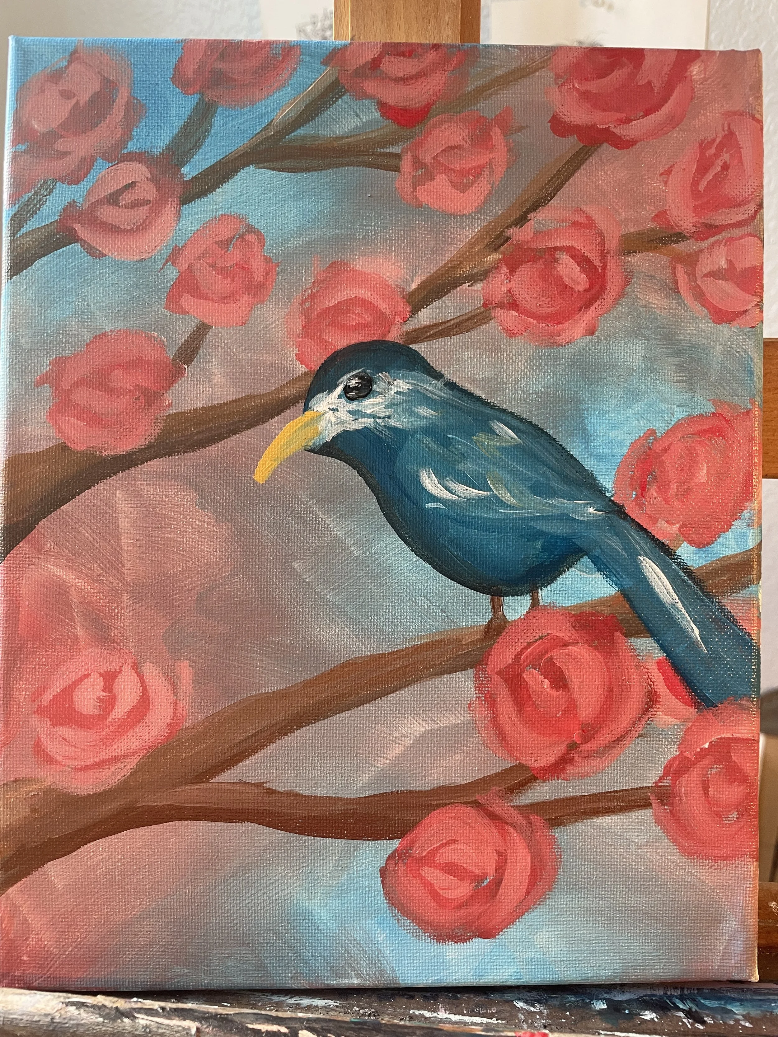 A painting of a blue bird perched on a branch surrounded by pink roses and muted background colors.