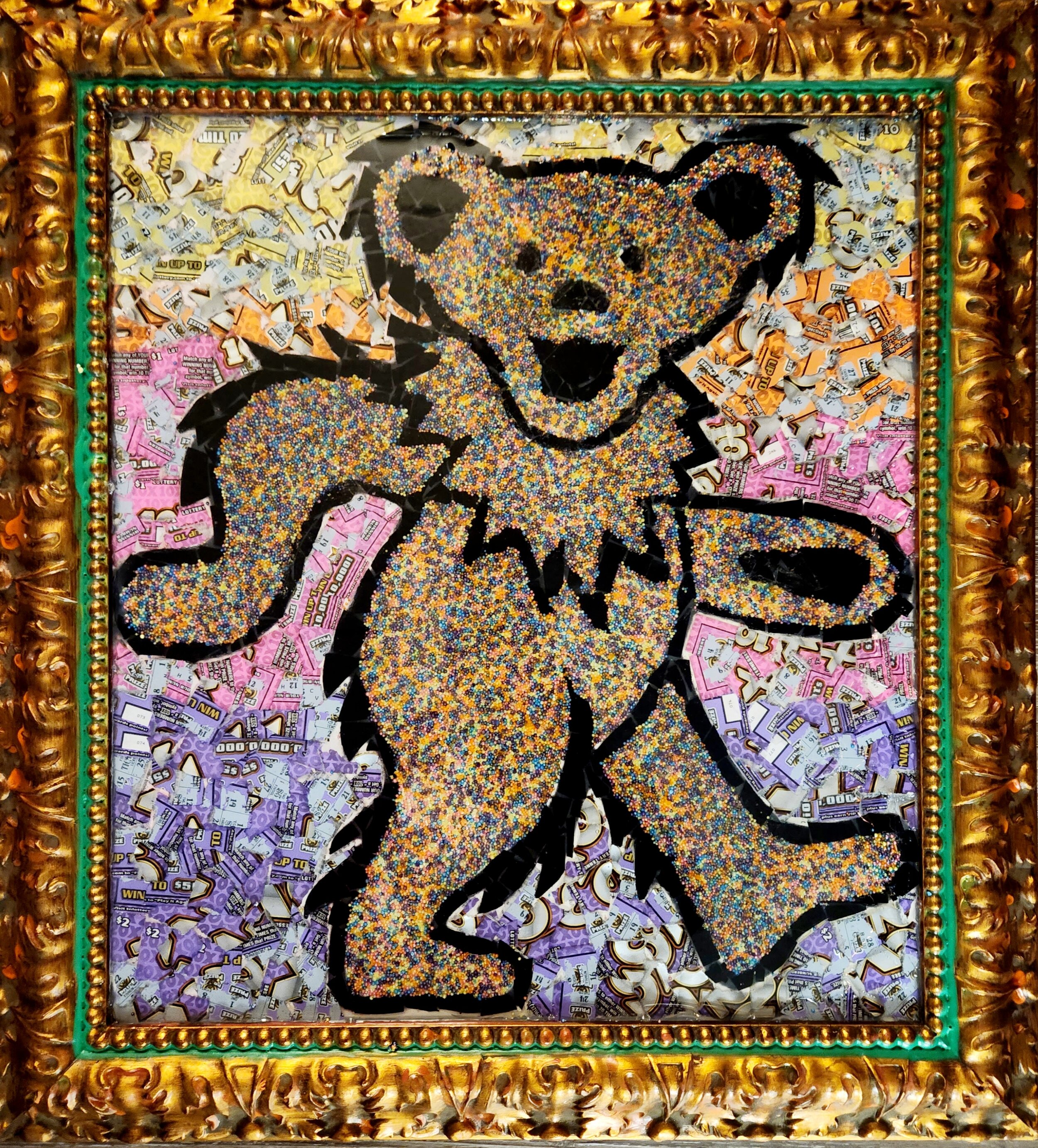 A framed mosaic of a lively cartoon-style bear made of colorful sprinkles, with a happy expression, sitting against a background of assorted lottery tickets. Grateful Dead. Dancing Bear. Jerry Garcia.