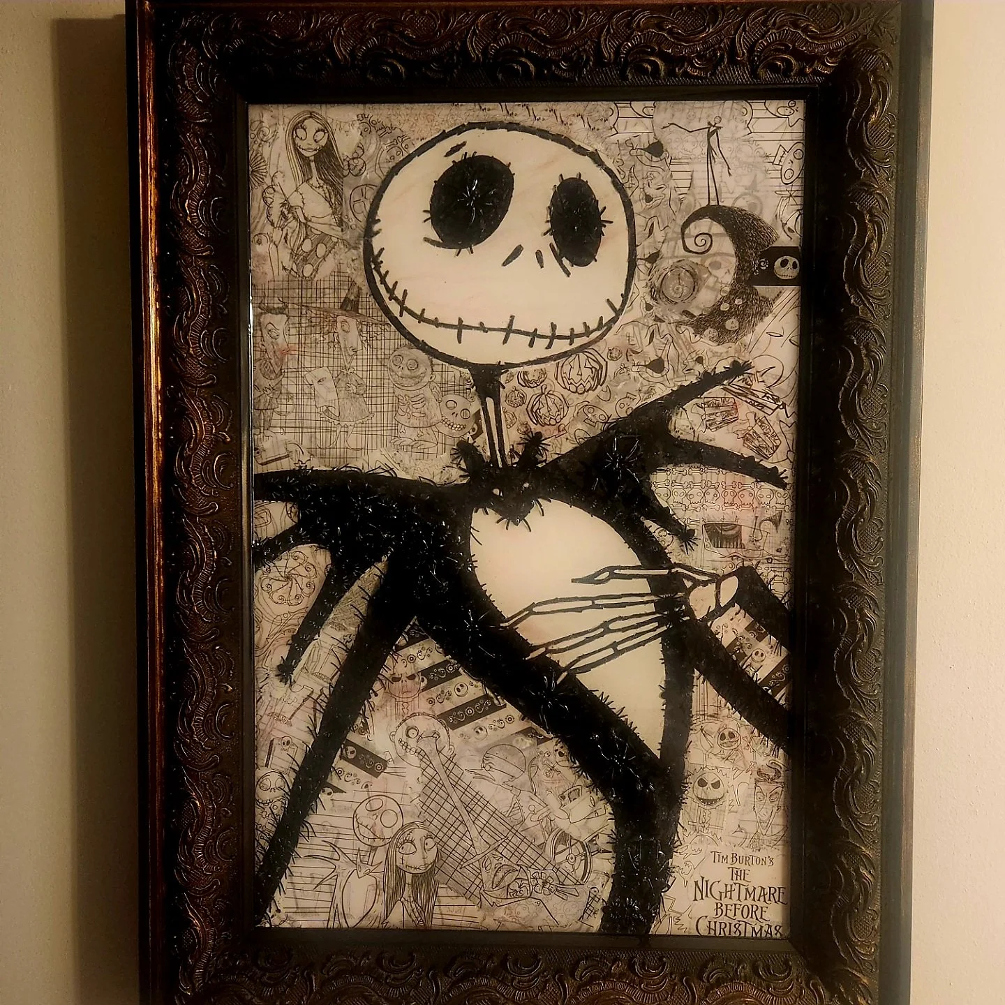 Framed artwork featuring Jack Skellington from 'The Nightmare Before Christmas' with a collage background of various characters and scenes from the movie.