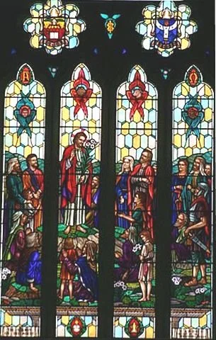 Colorful stained glass window depicting religious figures and scenes