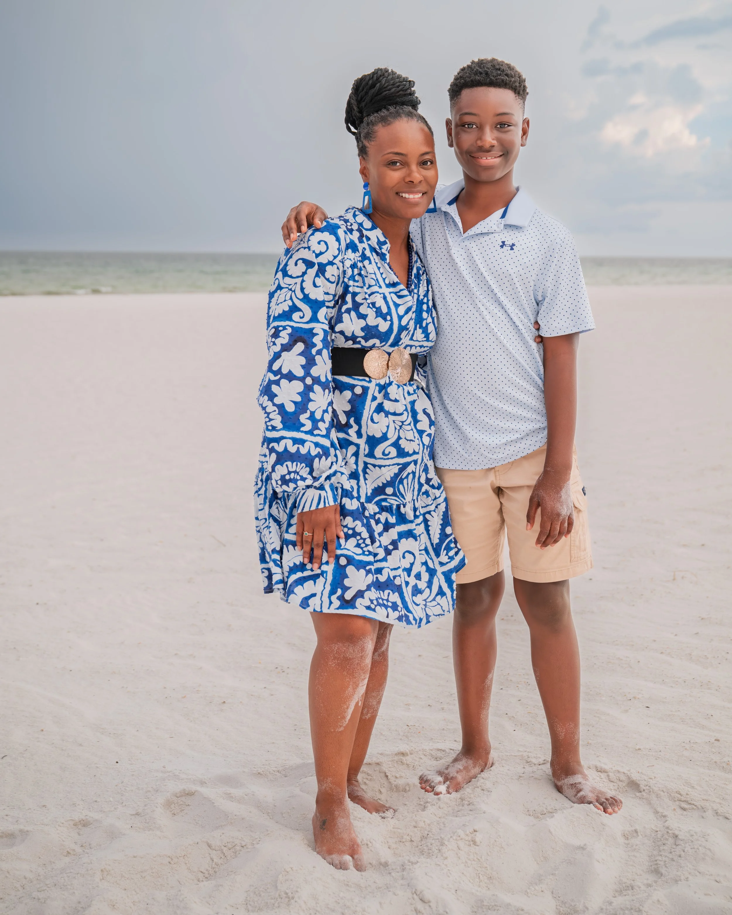 Mother and son embrace each other for a beautiful picture on the beach. 