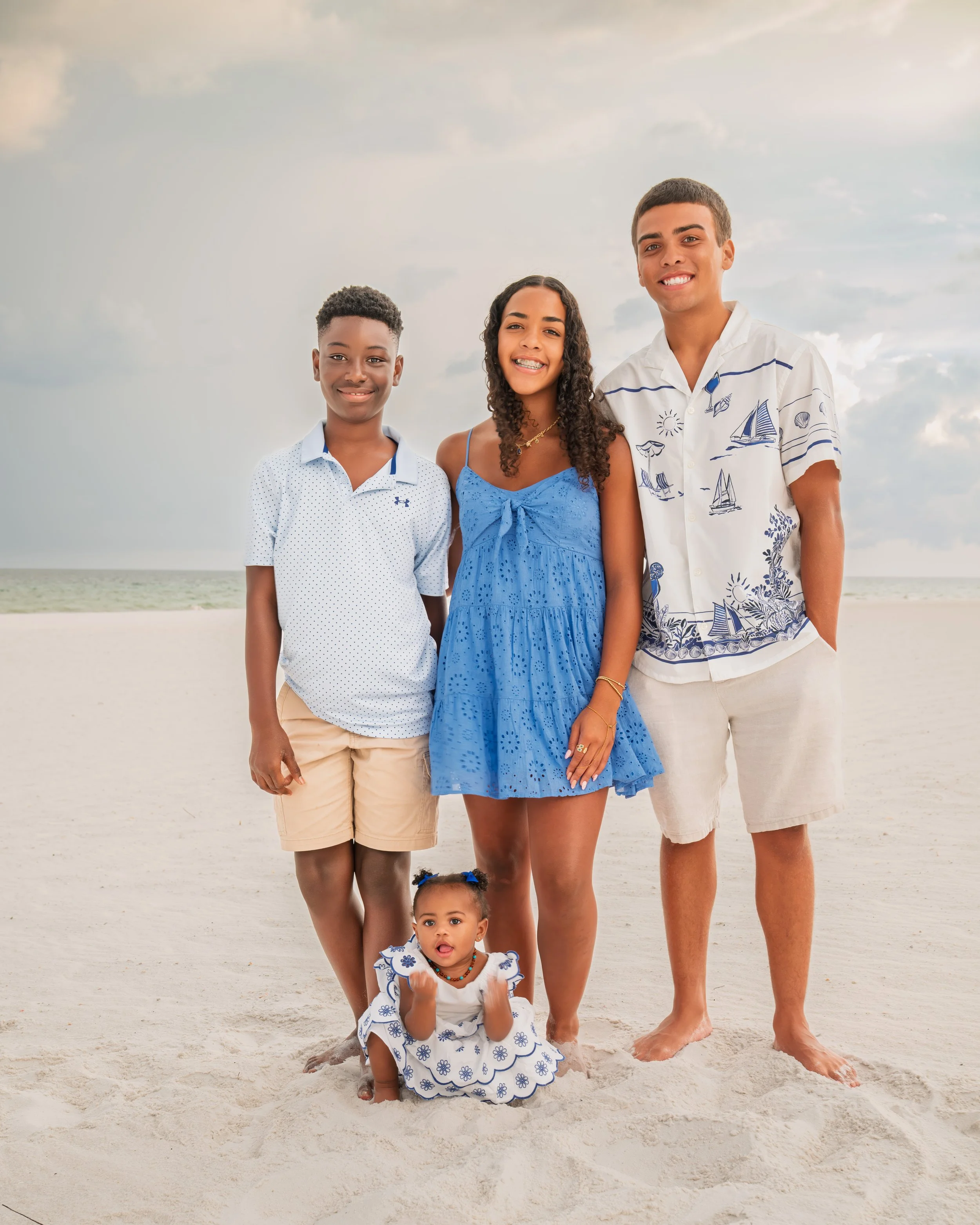 Siblings come together for family portraits on the beach.